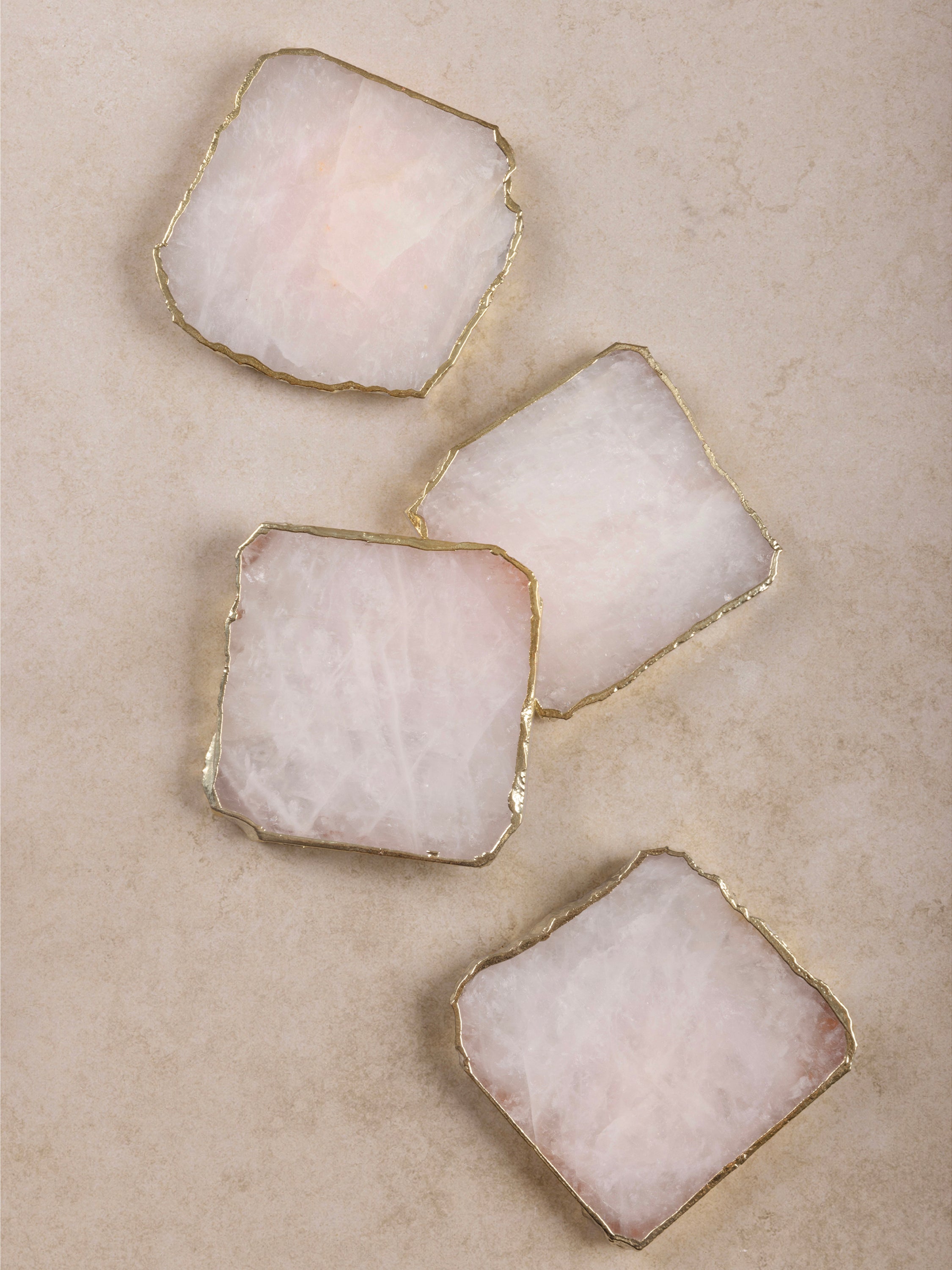 Elegant rose quartz coasters with gold edges – a luxurious addition to any home decor