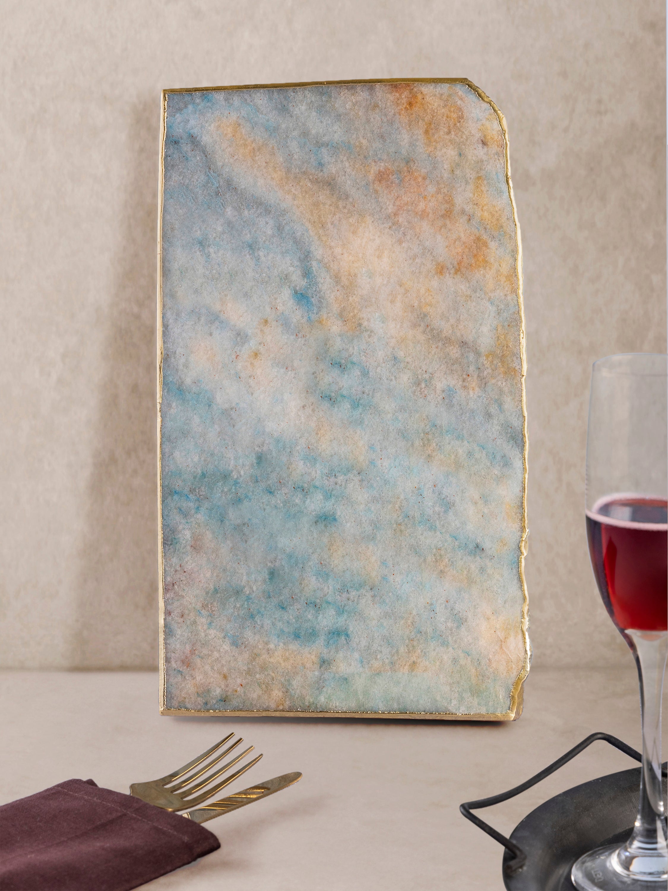Aventurine stone board shown upright, emphasizing thickness, straight edges, and natural mineral patterning with gold edge detailing
