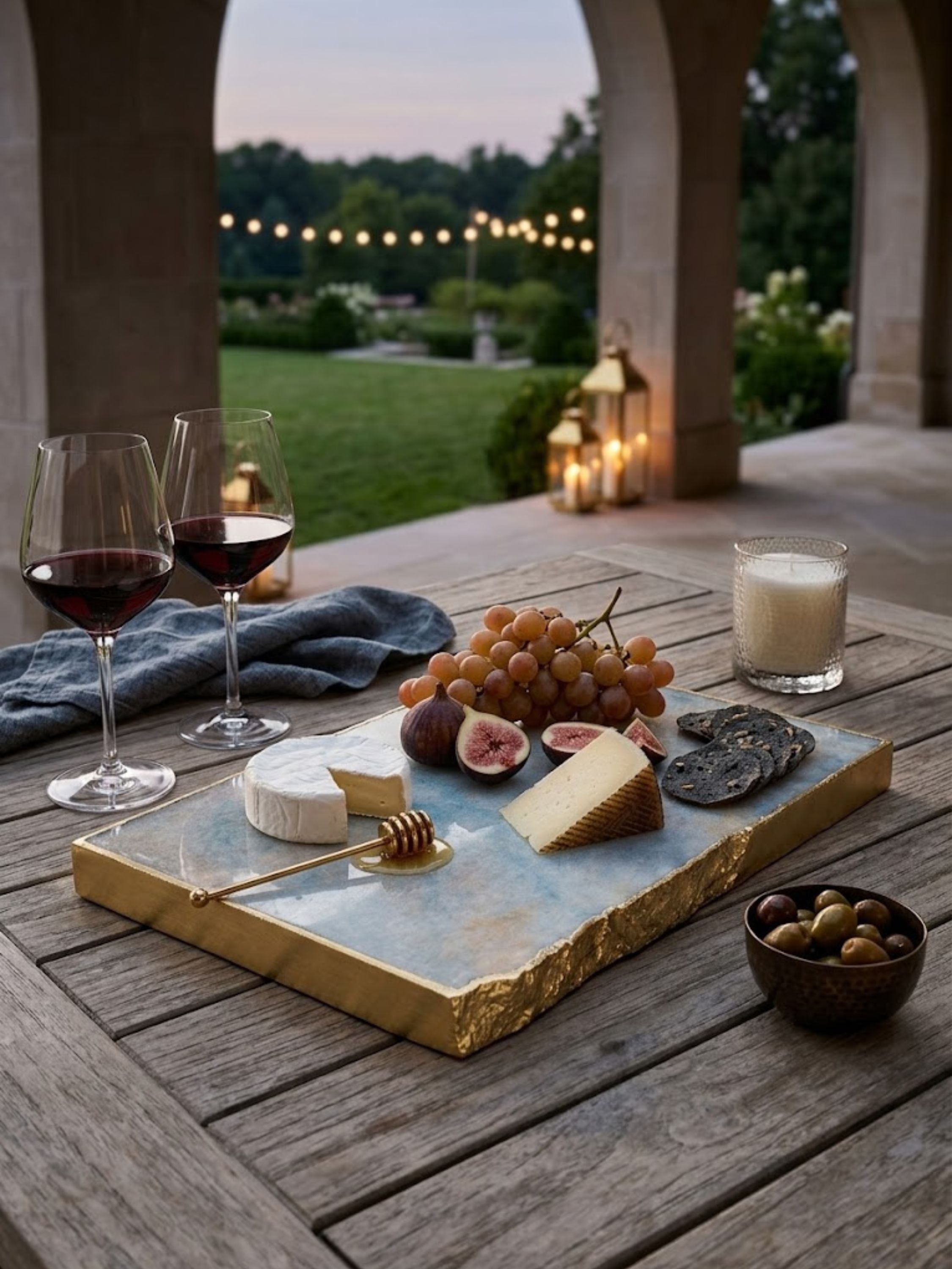 Aventurine stone cheese board with a faint mineral shimmer, styled on an outdoor terrace.