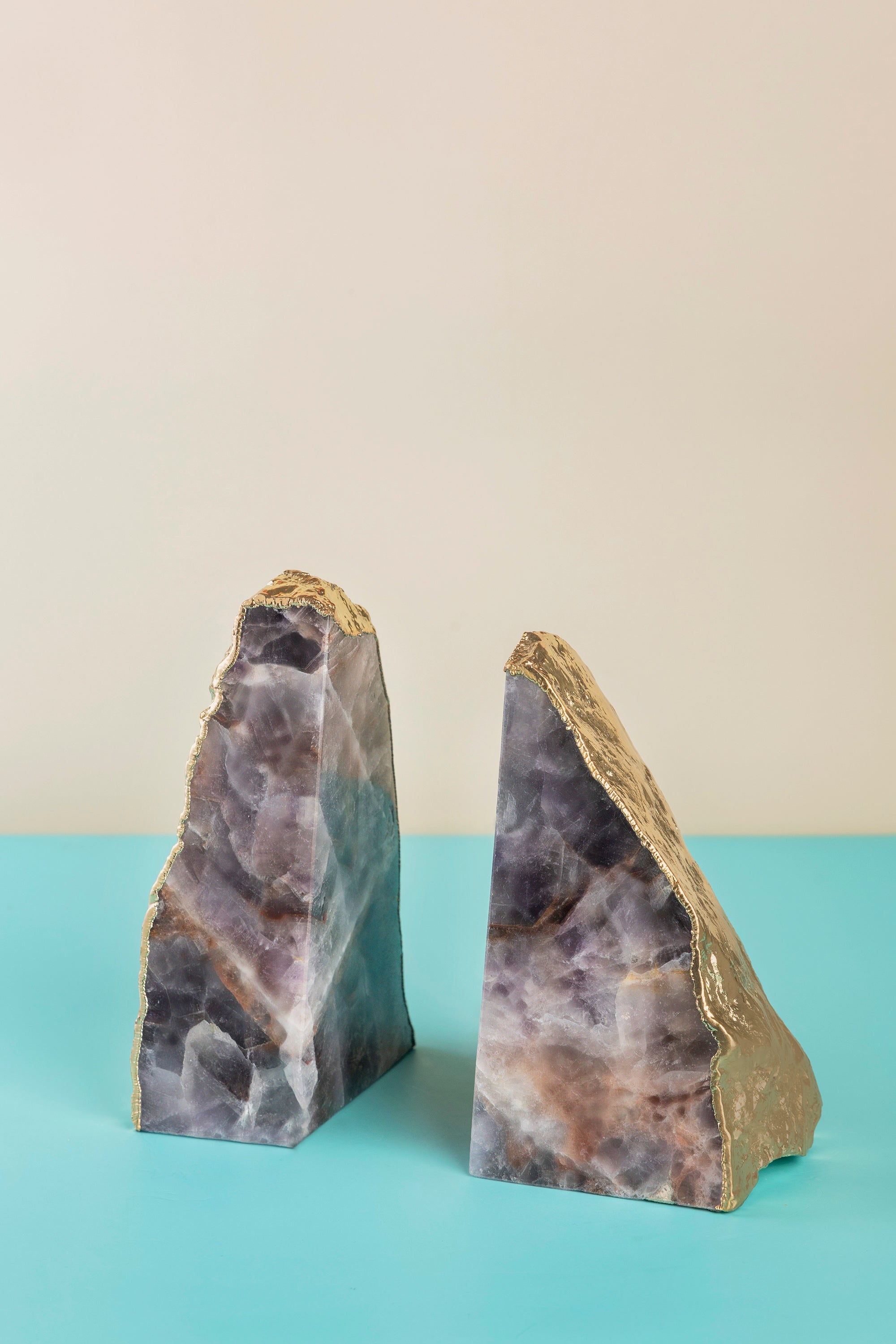 Luxurious natural amethyst stone bookends with gold trim for a sophisticated home decor accent