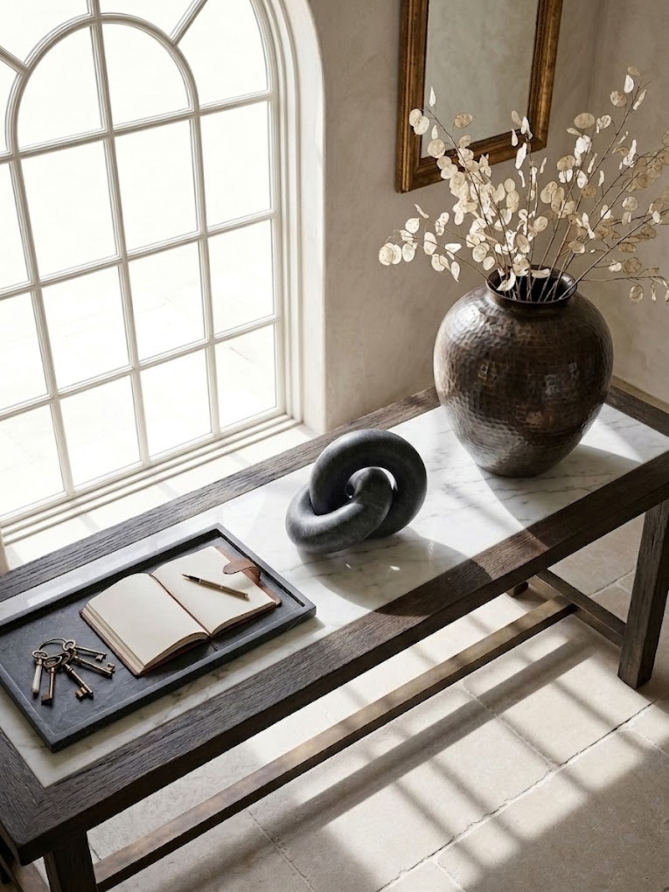 Munich black marble knot displayed on a console table, introducing bold sculptural form and contrast against neutral interiors.