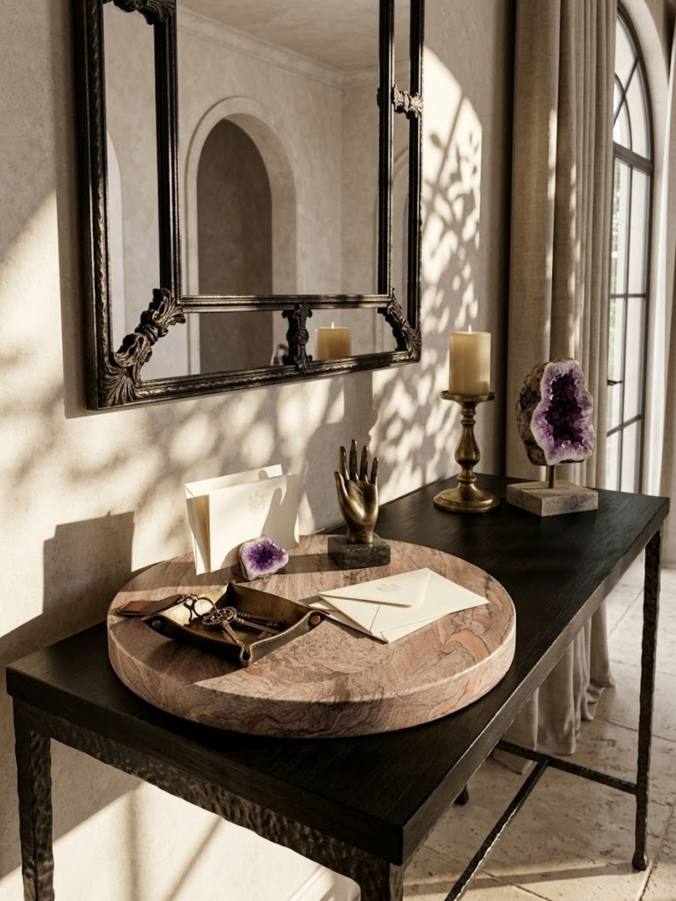 Ikoy brown onyx round tray styled on a console table with stationery and decorative objects in warm natural light.
