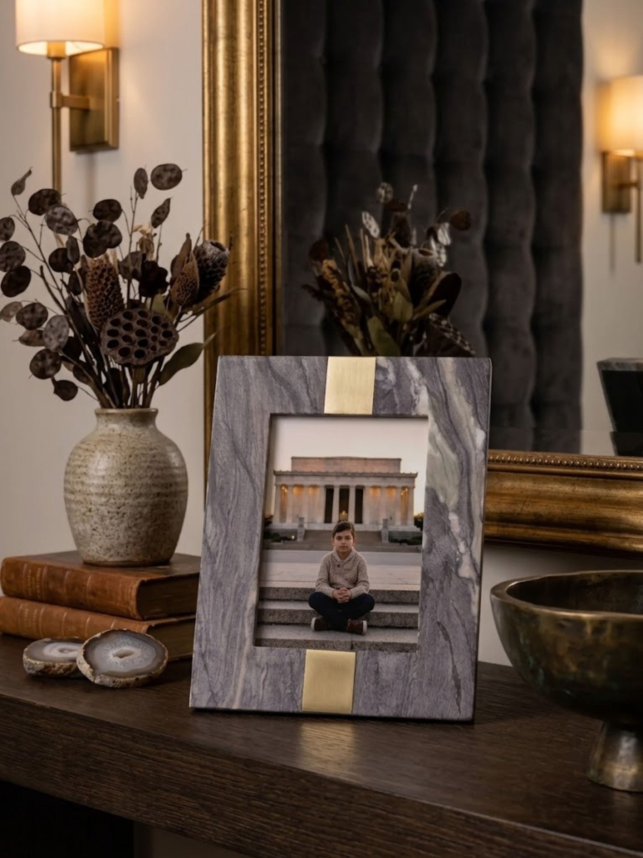 Mocha brown onyx picture frame with a wide flat border, styled on a console table.