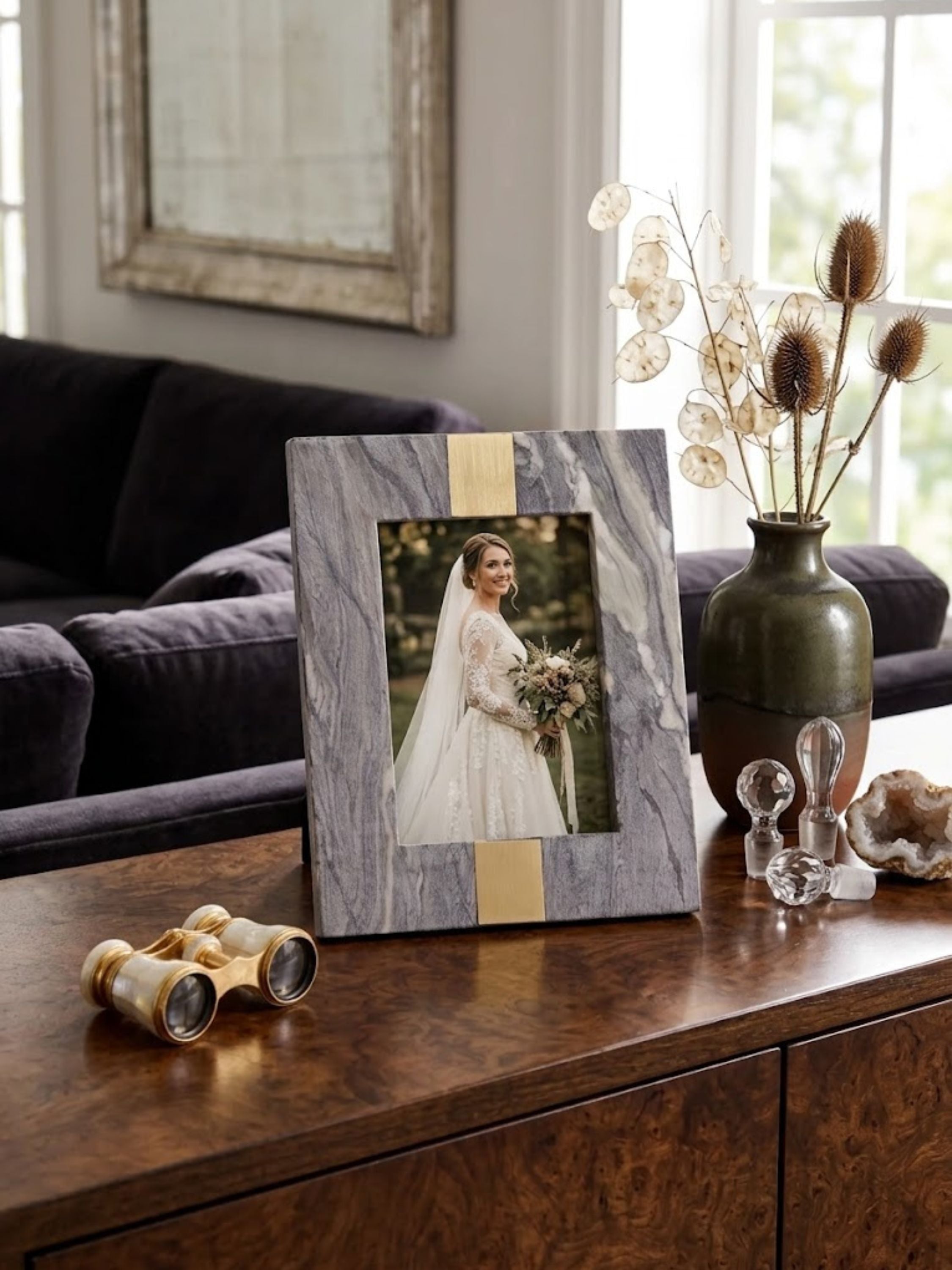 Mocha brown onyx picture frame cut from a solid slab with mineral pooling, styled on a table with books.