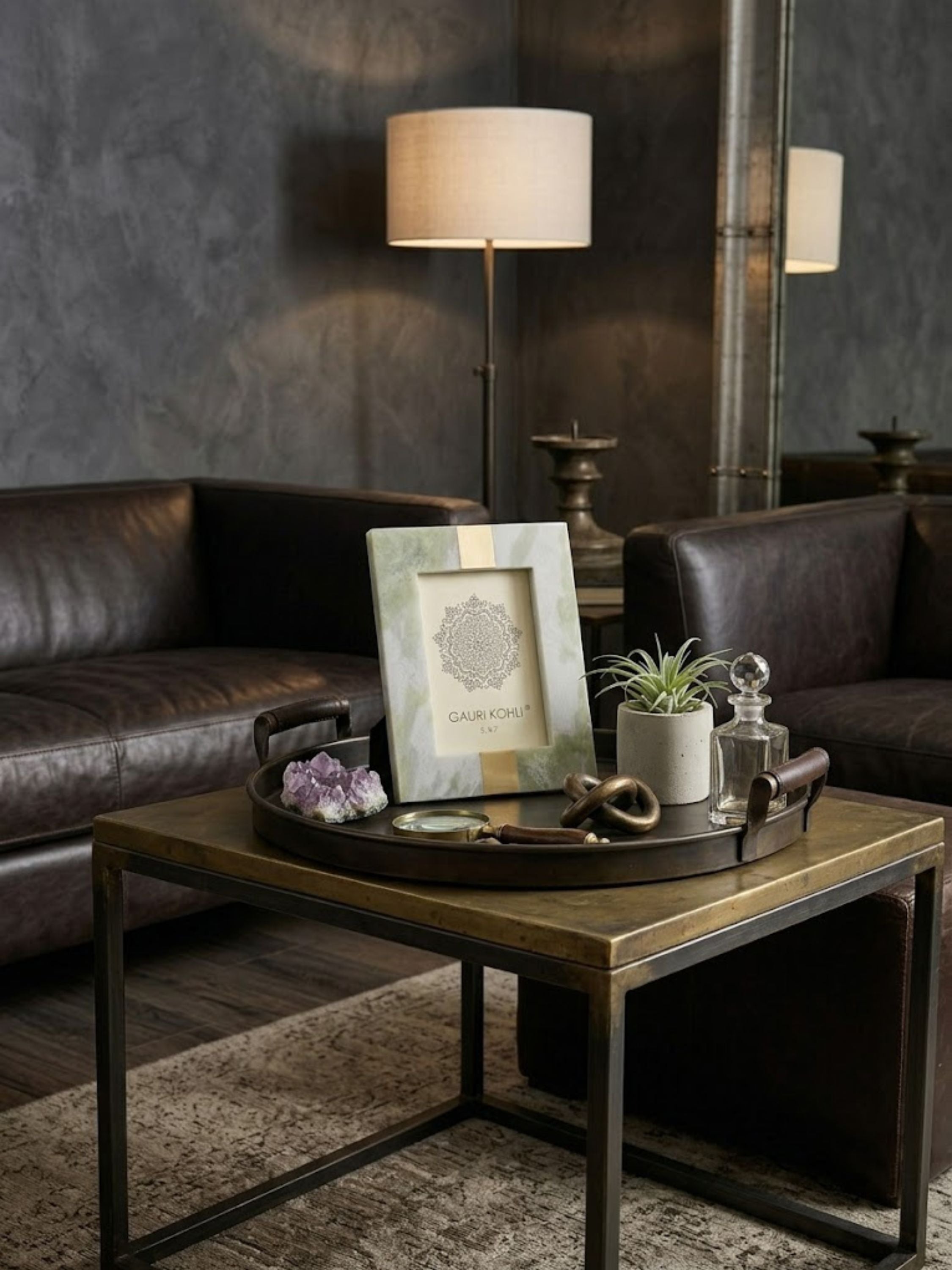 Skye green onyx picture frame styled on a brass coffee table tray within a leather lounge setting, highlighting soft sage mineral tones and refined material contrast.