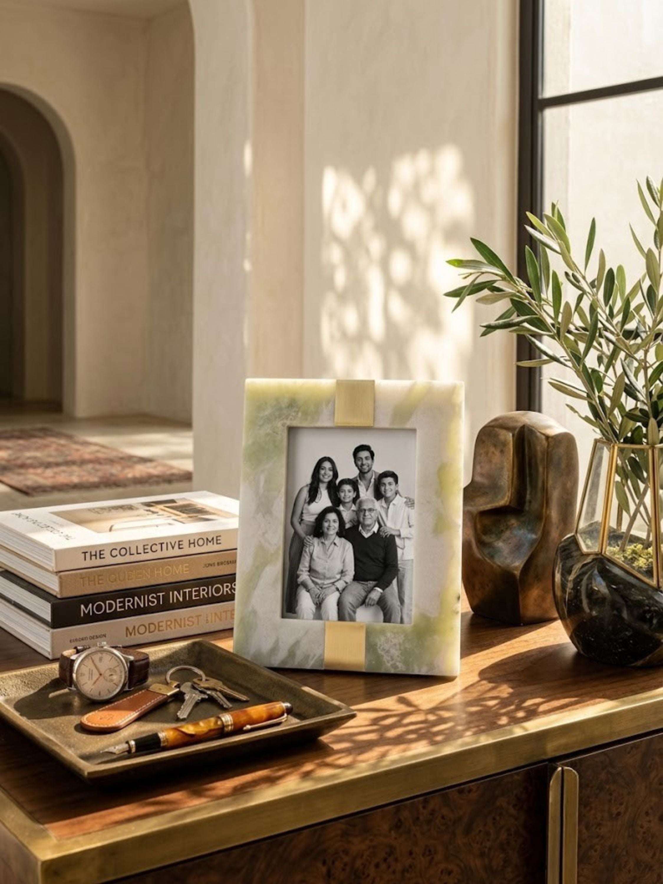 Green onyx picture frame with a close-grained texture, styled on a console table.