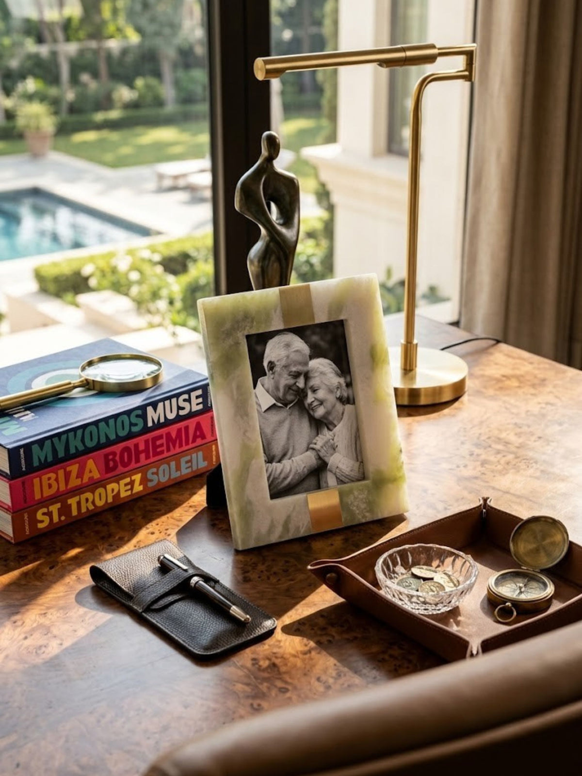 Green onyx picture frame with mineral-veined stone detail, styled on a home office desk.