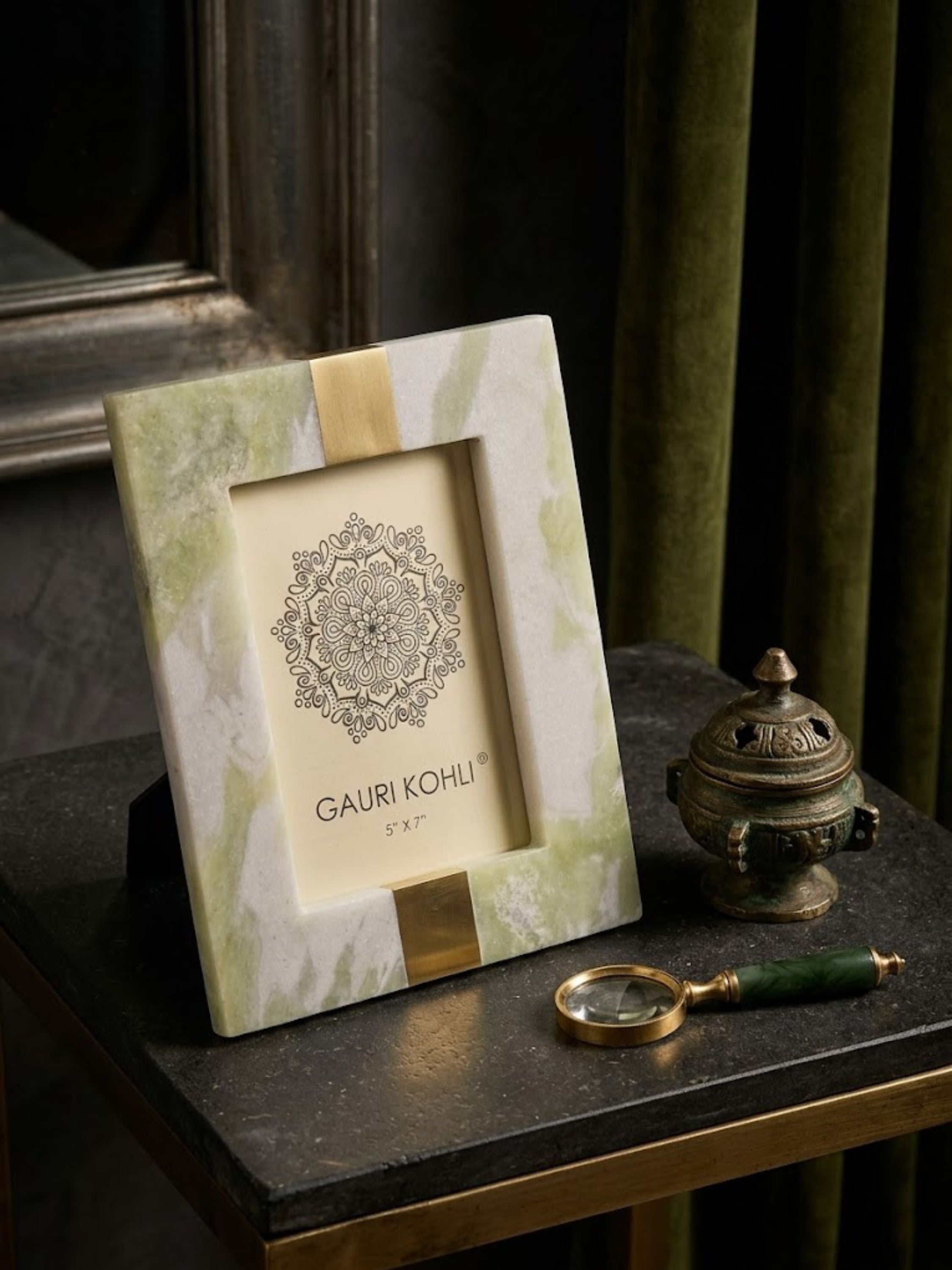 Skye green onyx picture frame arranged on a dark stone console with sculptural décor and floral accents, emphasizing layered textures and gentle green veining.