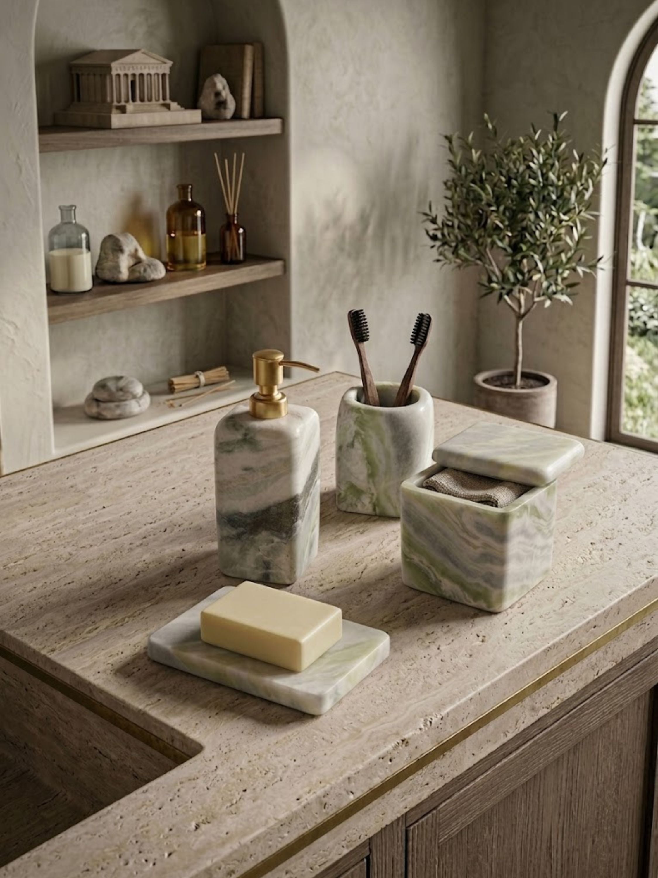 Hanoi green onyx bath accessories set styled on a travertine vanity, featuring a soap dispenser, toothbrush holder, canister, and soap dish with soft mineral movement.