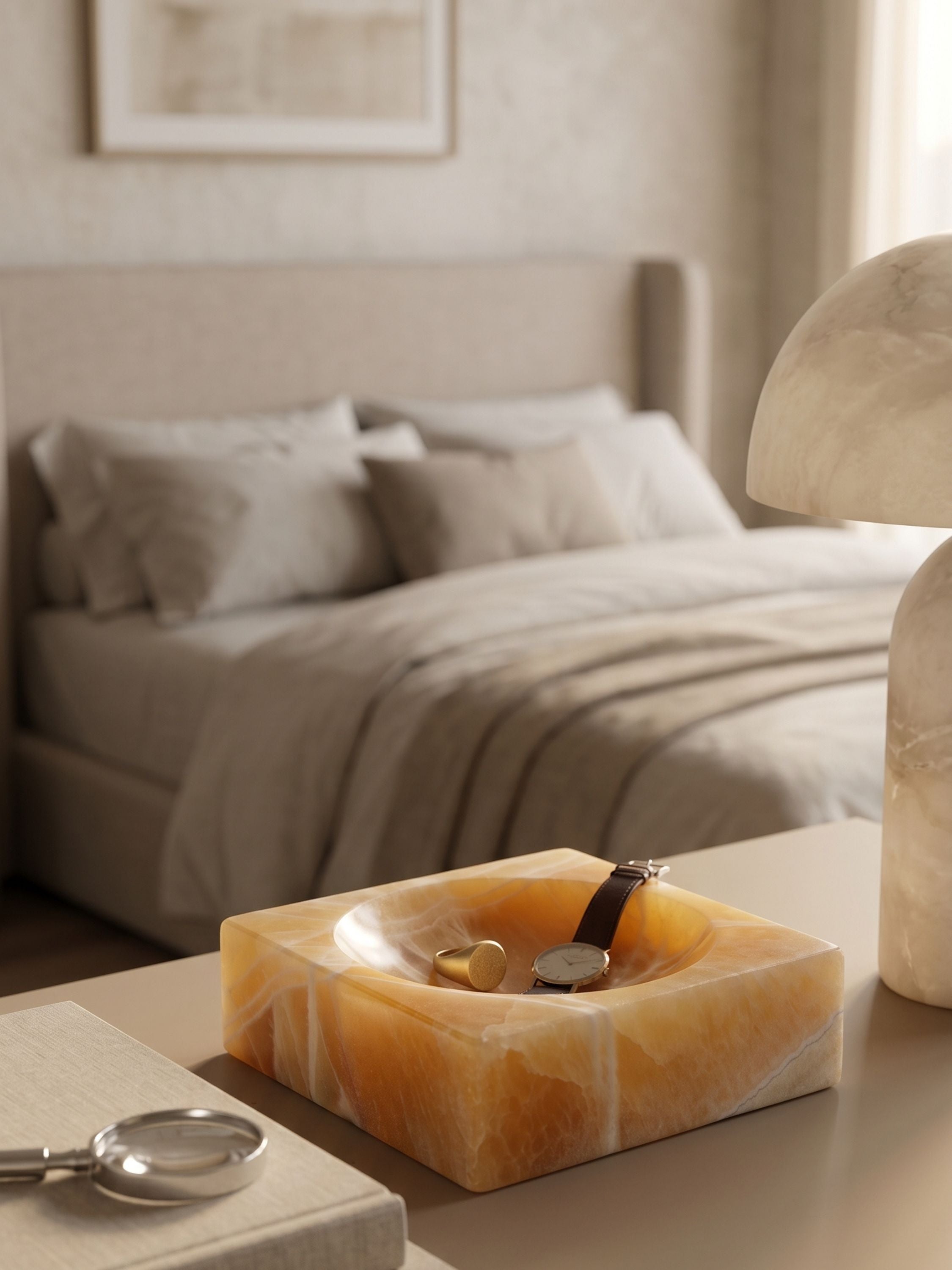Marigold onyx jewelry bowl styled on a bedside table, holding everyday essentials with its warm stone character and amber translucency.