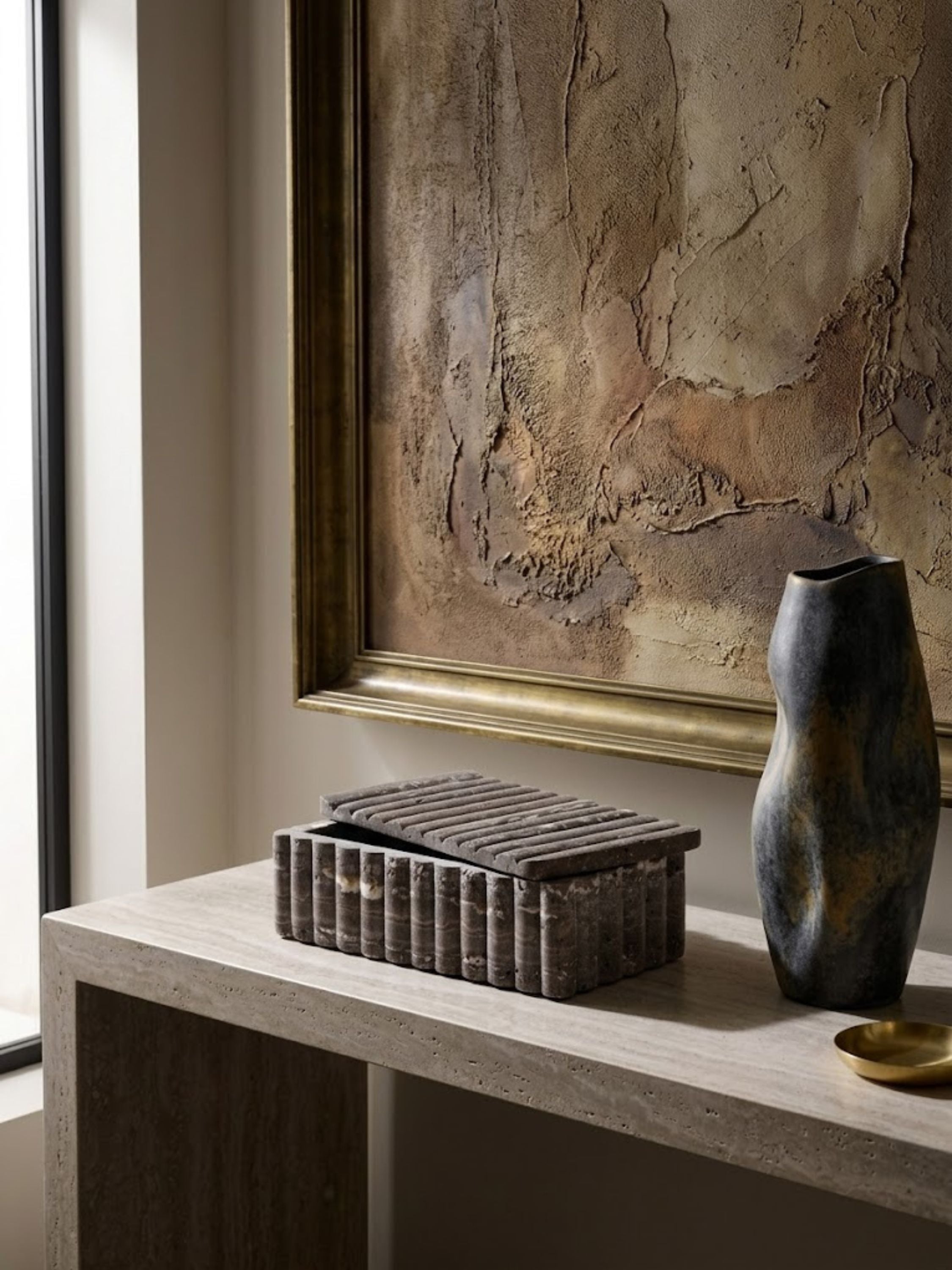 Ribbed travertine decorative box displayed on a console table, highlighting its architectural silhouette, carved stone detailing, and refined concealed storage.