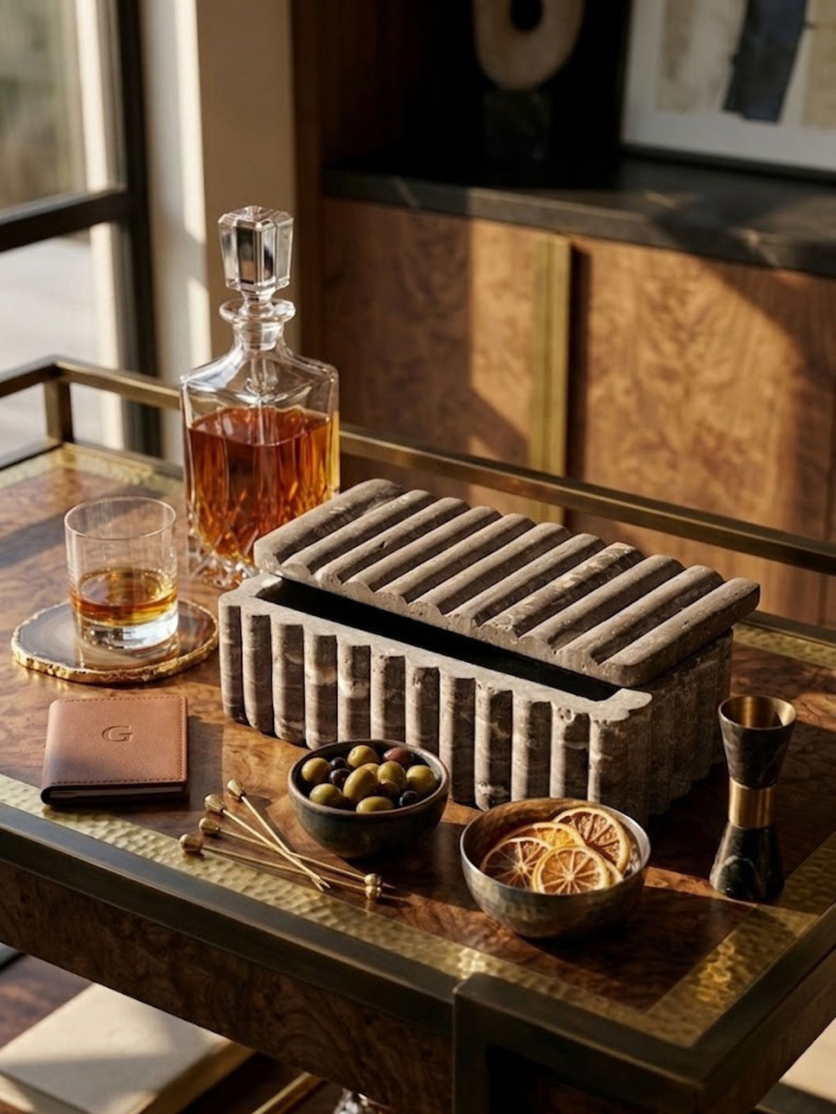 Gray travertine box with natural stone banding, styled on a bar cart.