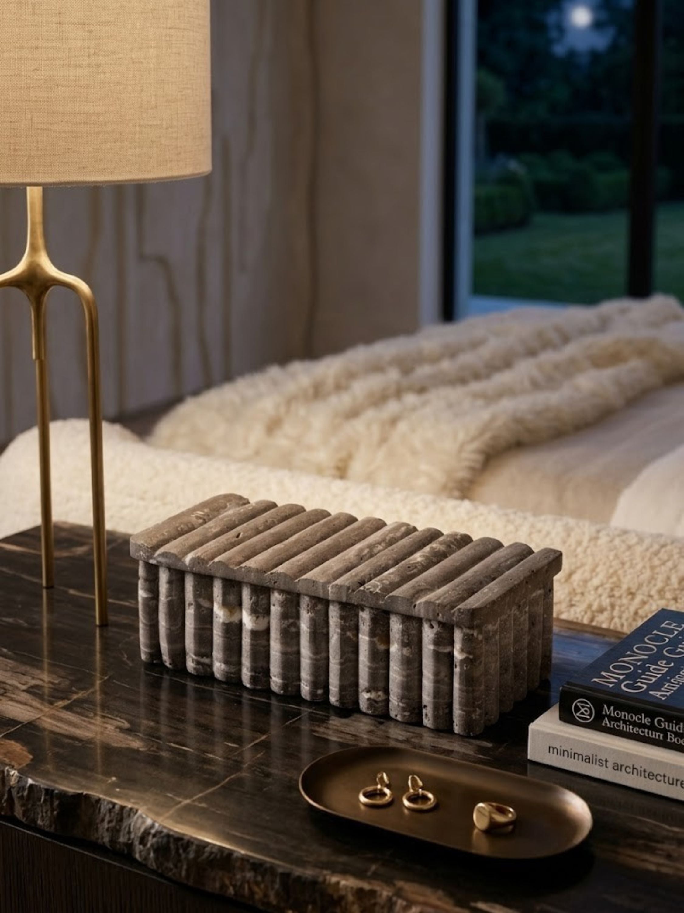 Gray travertine box with a ribbed lid, styled on a bedroom nightstand.