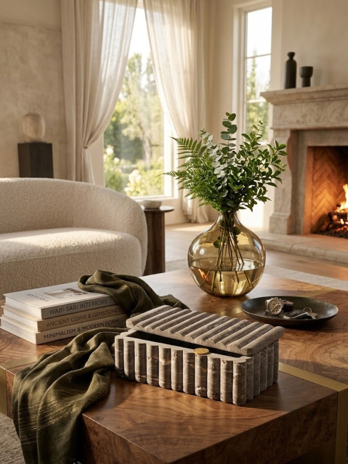 Gray travertine box with rounded fluting, styled on a coffee table in a living room.