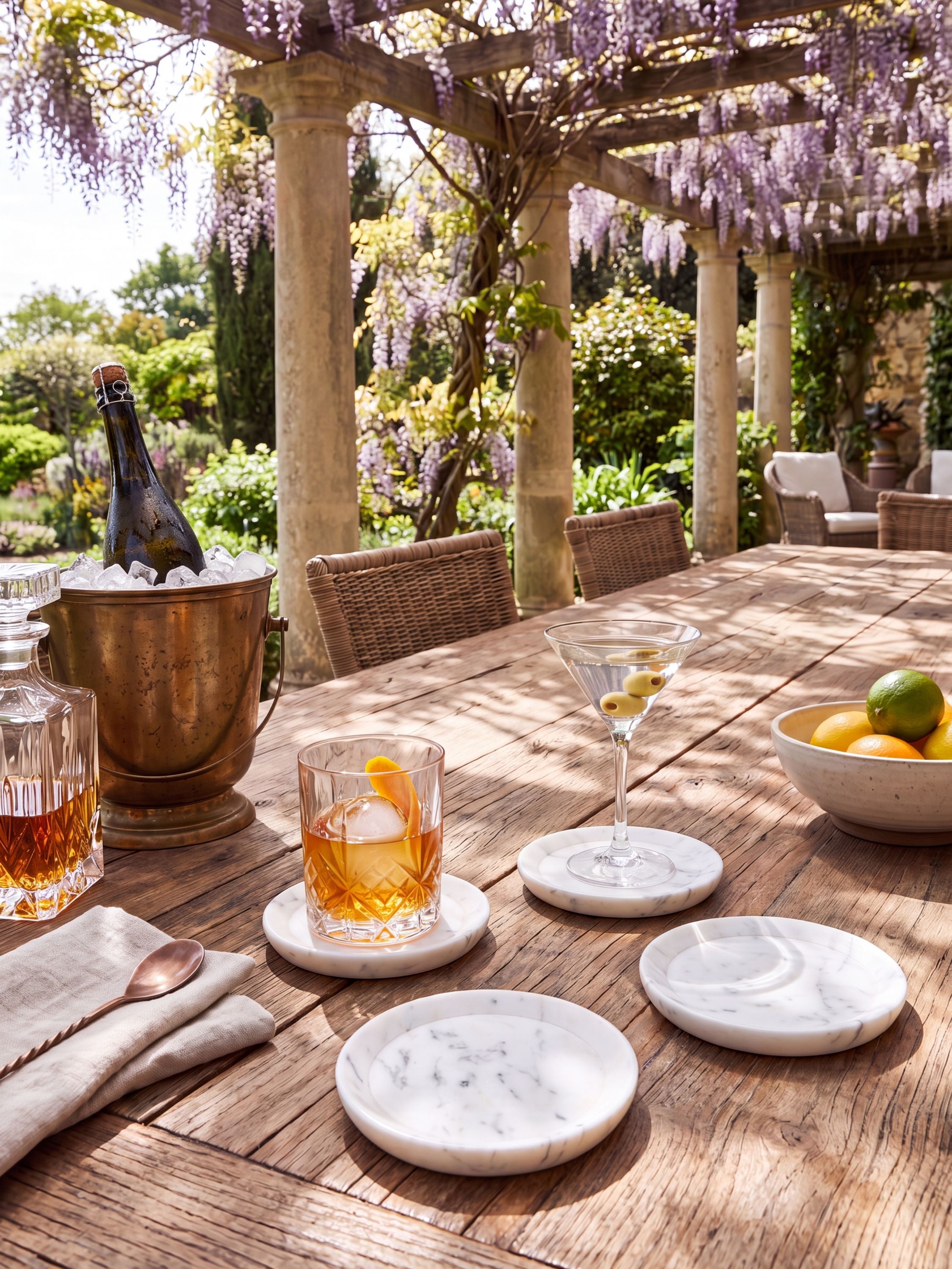 White marble coasters with beveled edges, styled at an outdoor bar setting.