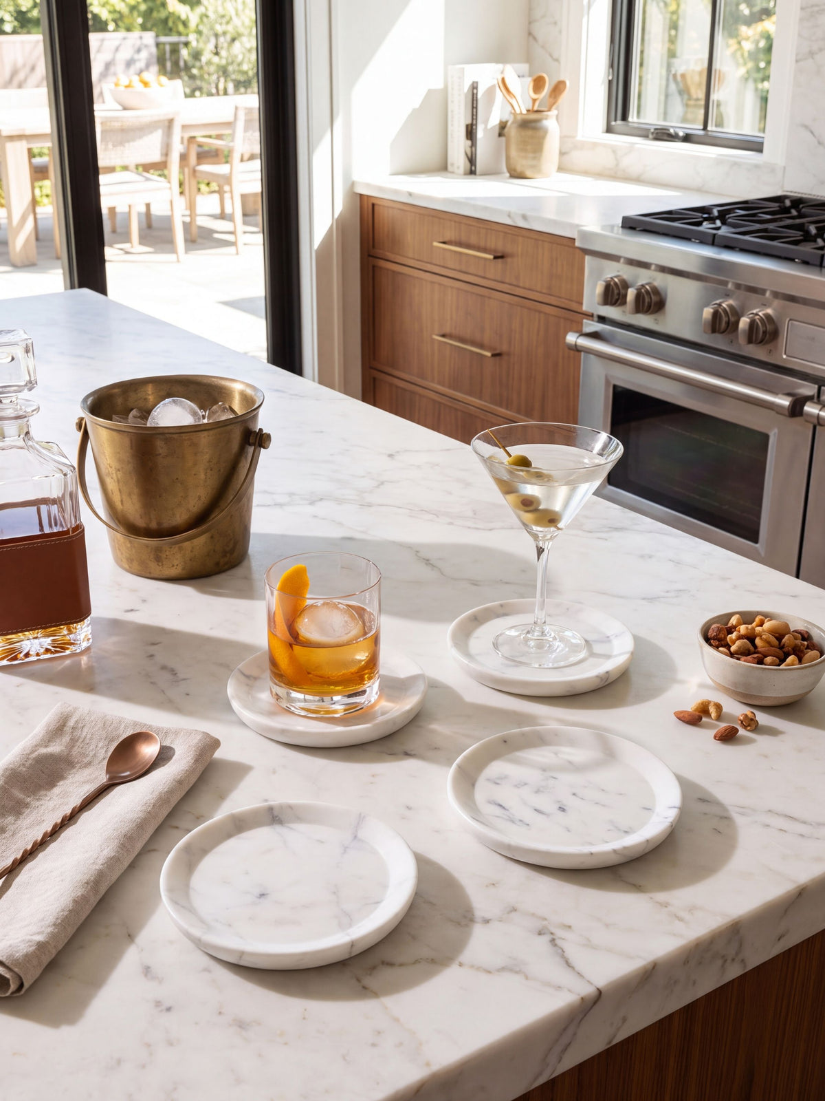 White marble coasters styled on a kitchen counter with a cocktail glass and cutting board.