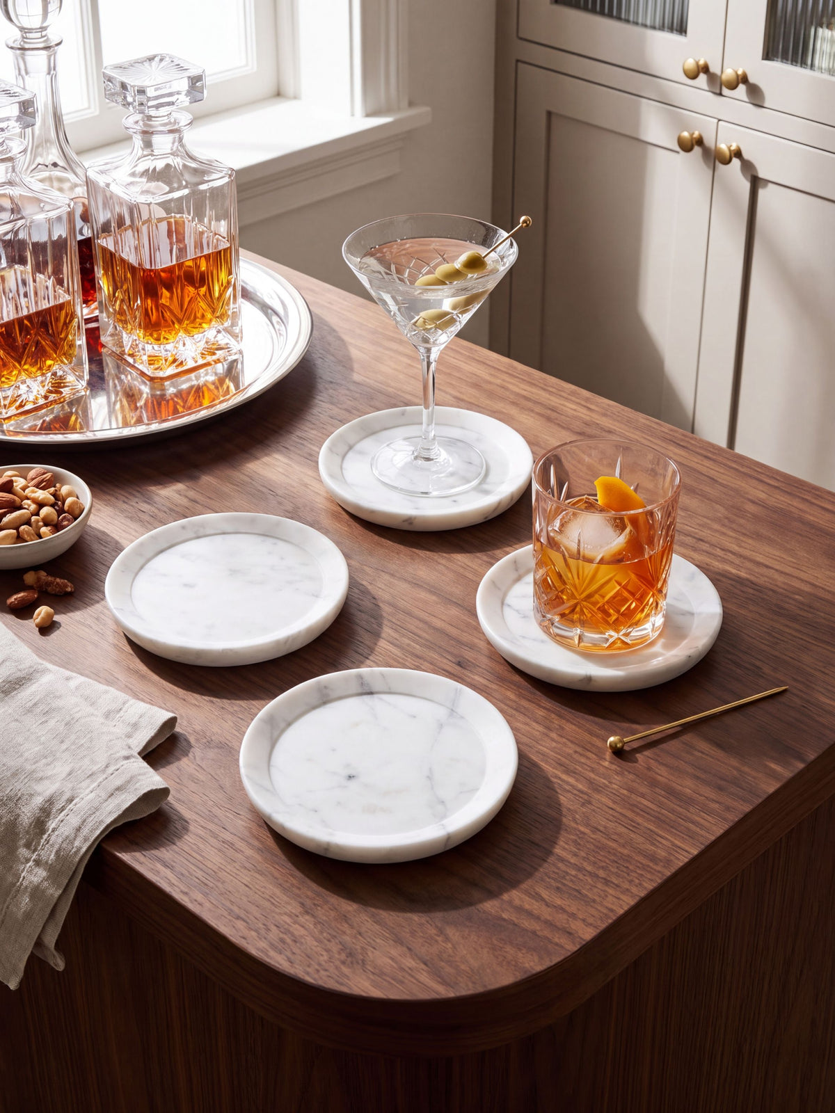 White marble coasters styled on a wood table with pastries and coffee.