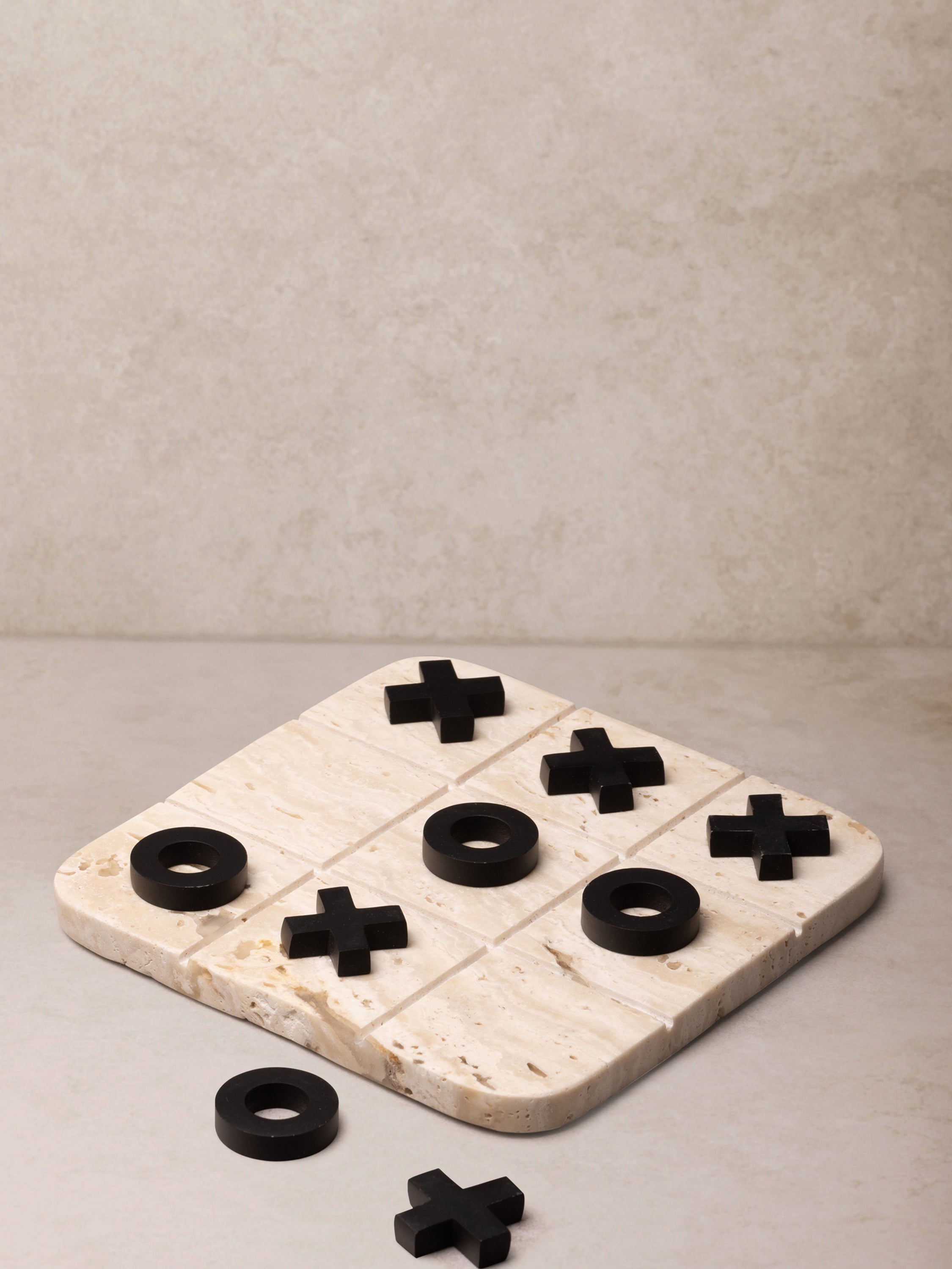 Luxury Marble Tic Tac Toe Set – A handcrafted beige marble board with black game pieces, perfect for stylish home décor and entertainment
