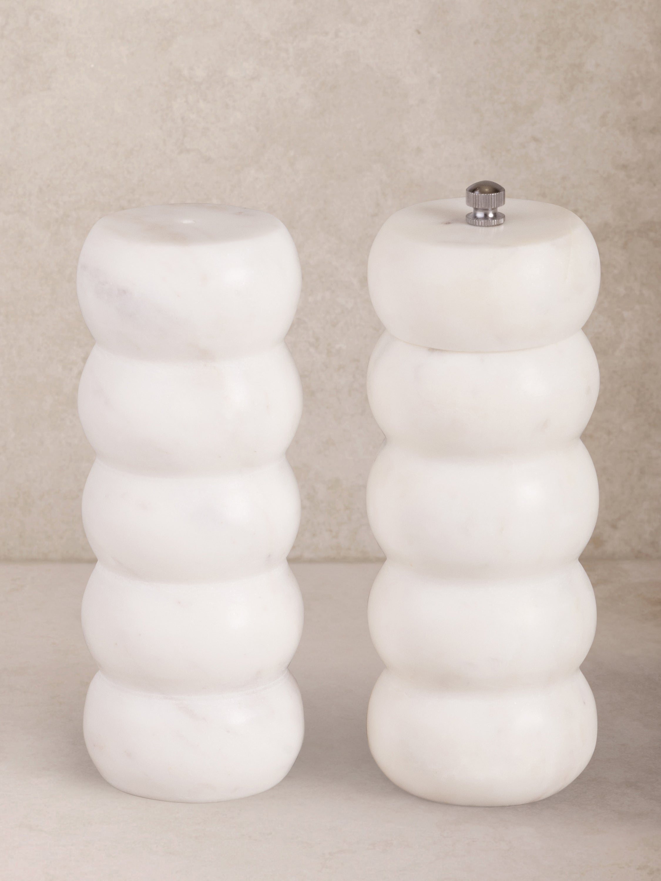 Elegant white marble salt and pepper set with sleek design, perfect for modern dining tables