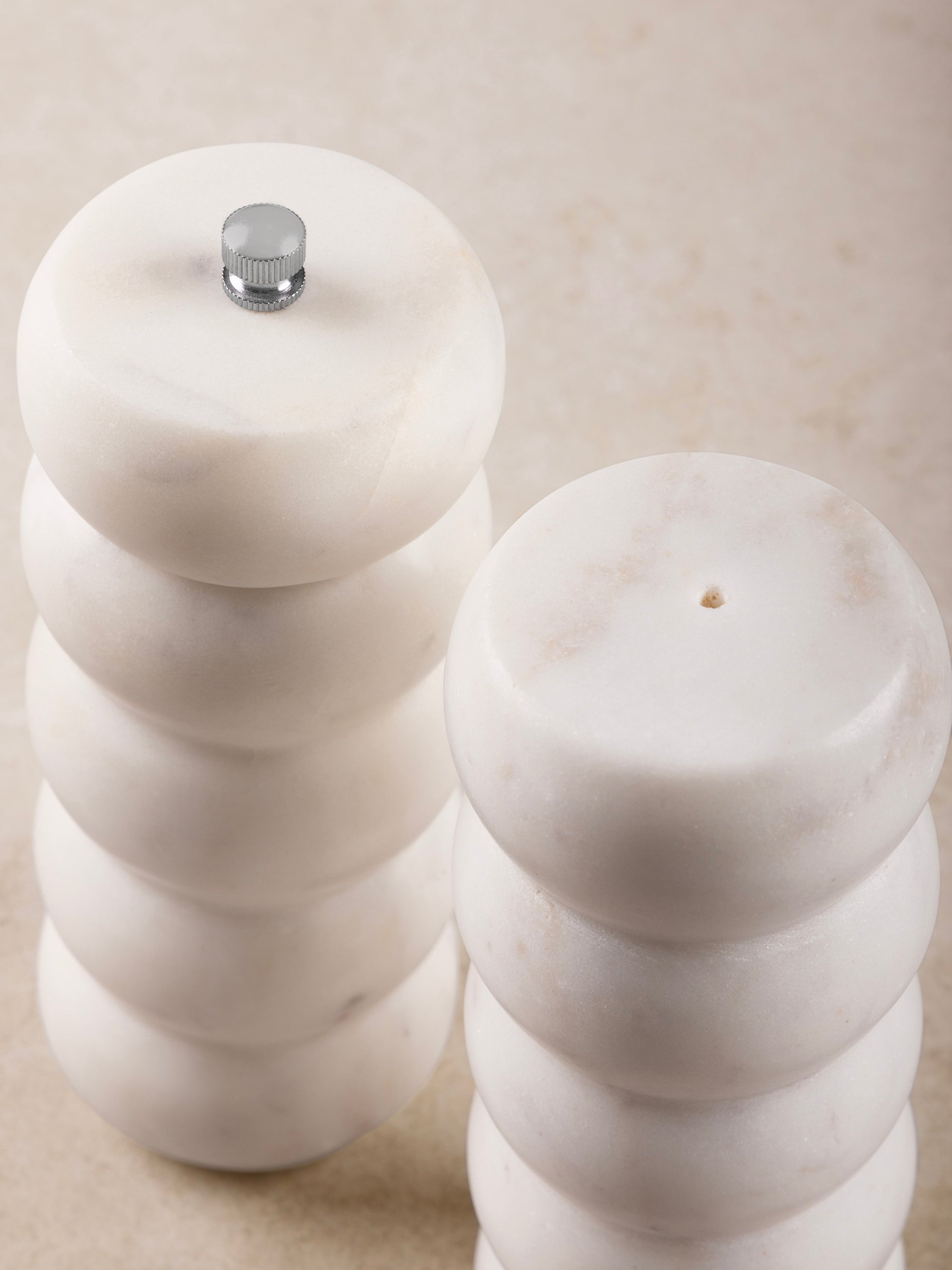 Chic white marble salt and pepper set featuring natural veining, perfect for everyday use or special occasions