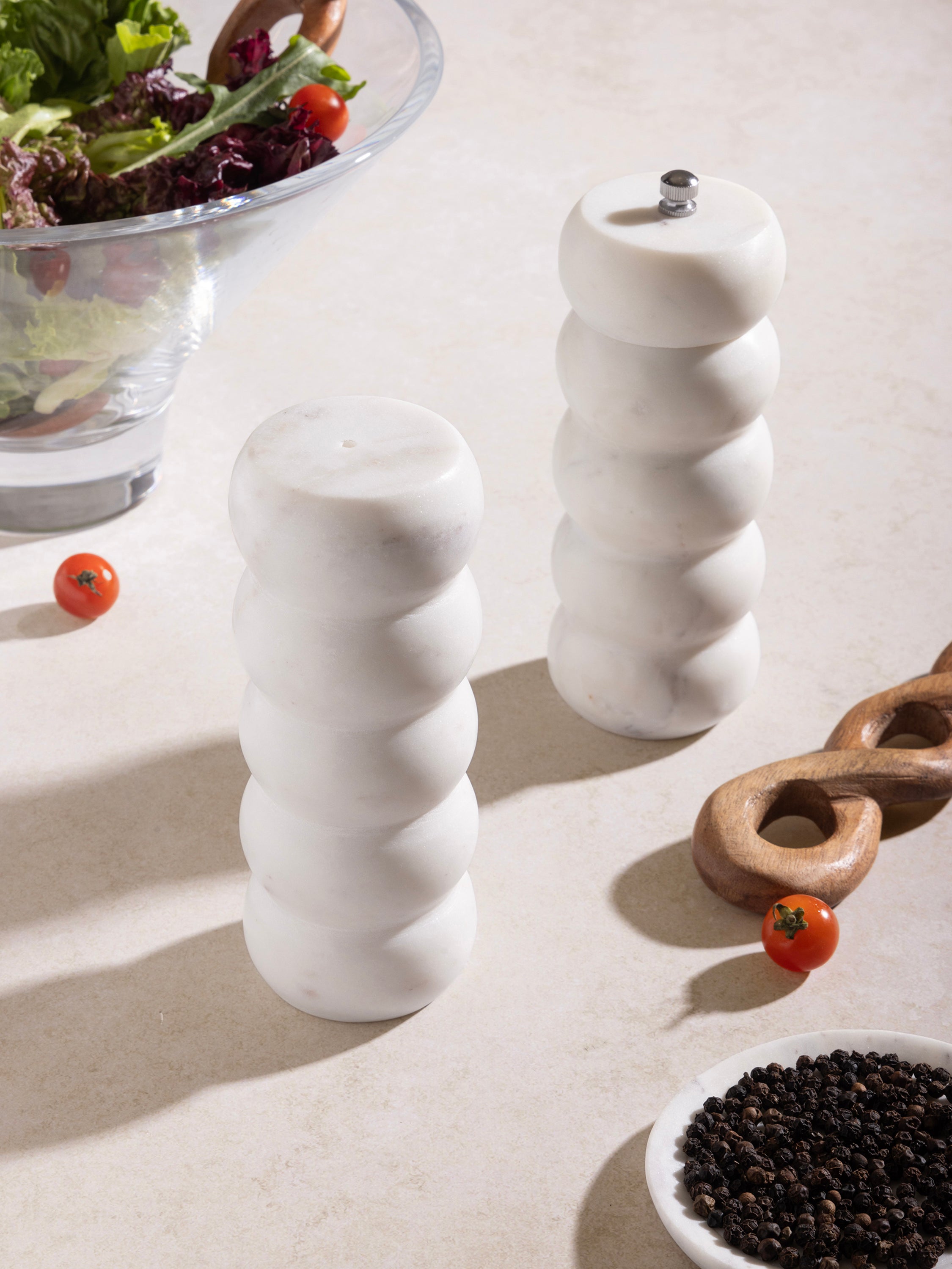 Sophisticated white marble salt and pepper shakers with polished finish, ideal for adding luxury to your kitchen