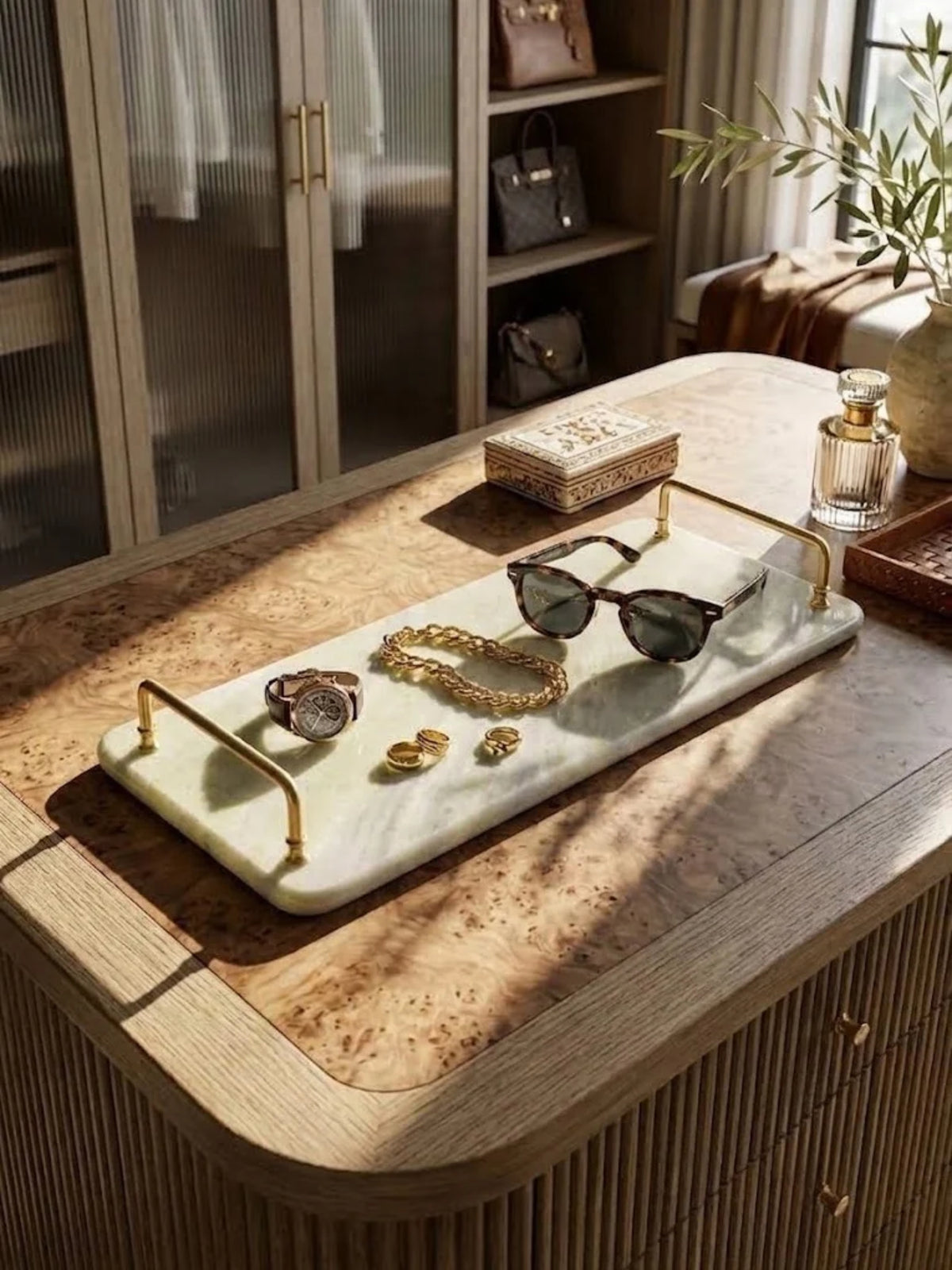 Osaka green onyx tray with brass handles, holding sunglasses and jewelry on an entryway console.