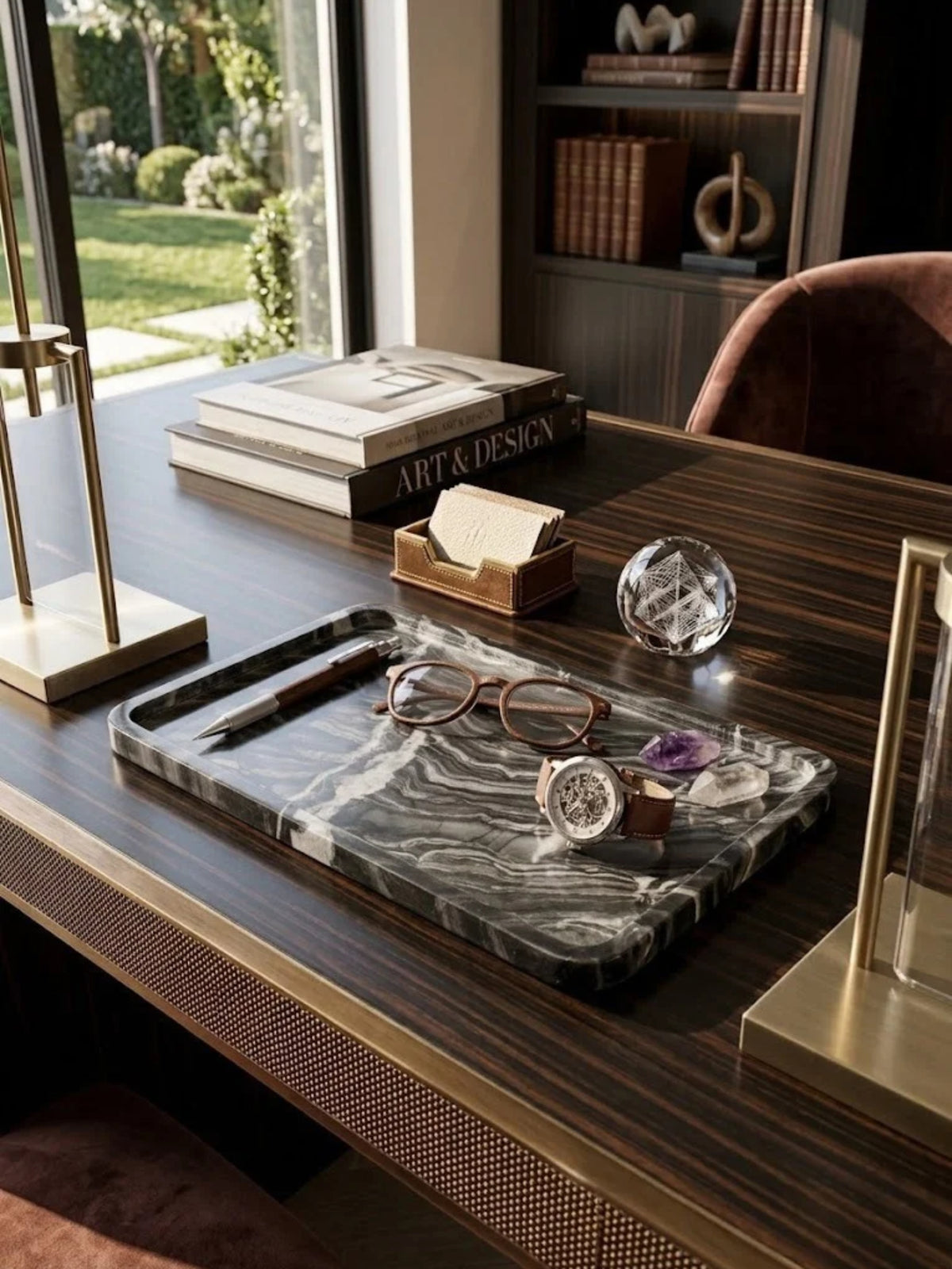 Frontier black onyx tray with sweeping veining, holding glasses and a watch on a desk.