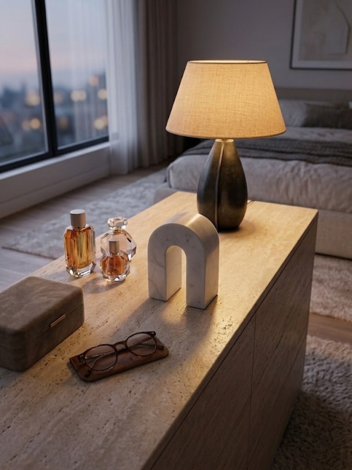 Matte white marble arch object, styled on a bedroom nightstand.