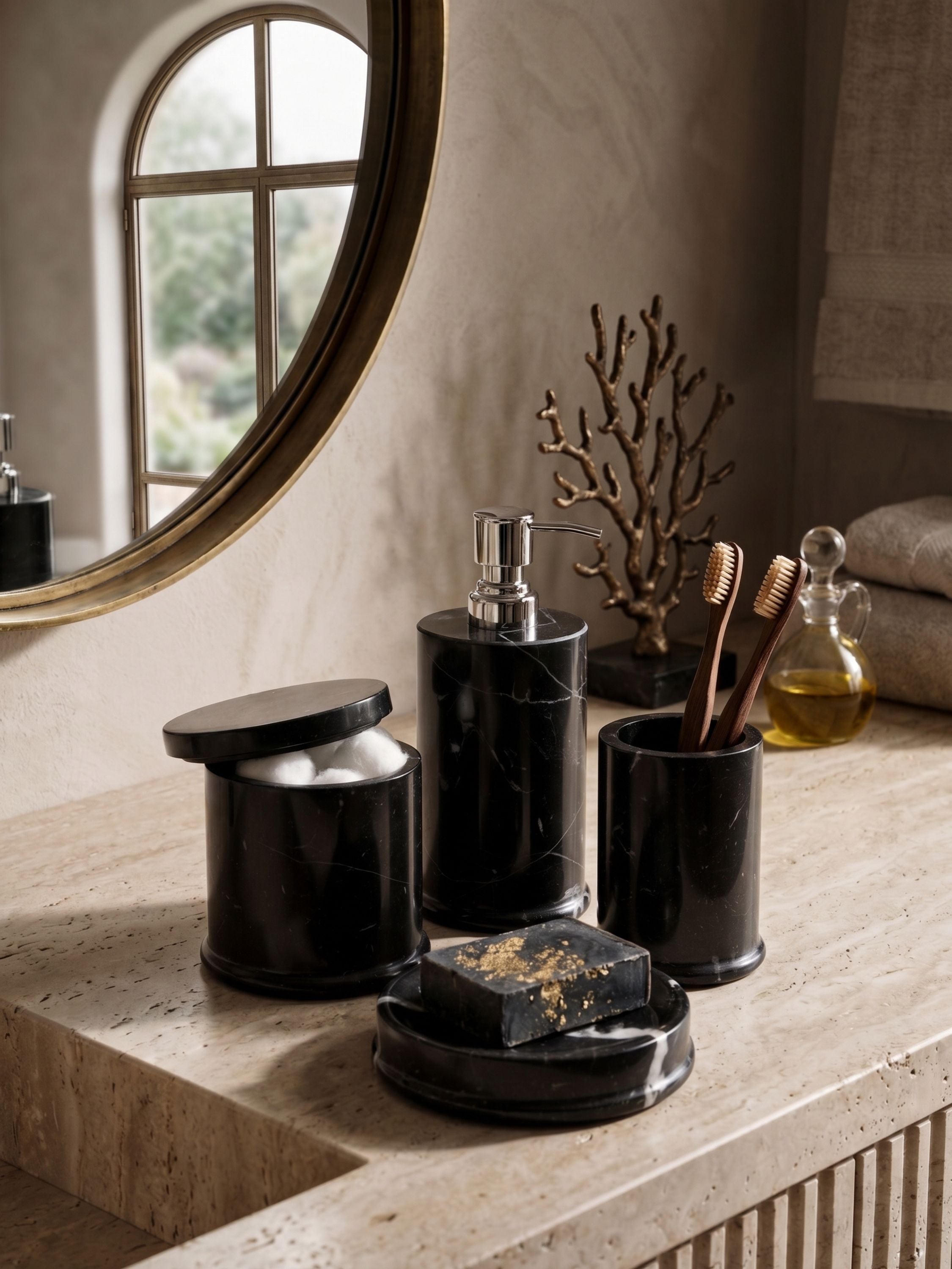 Black marble bathroom accessories set with soap dispenser, jar, and holder styled on a vanity countertop
