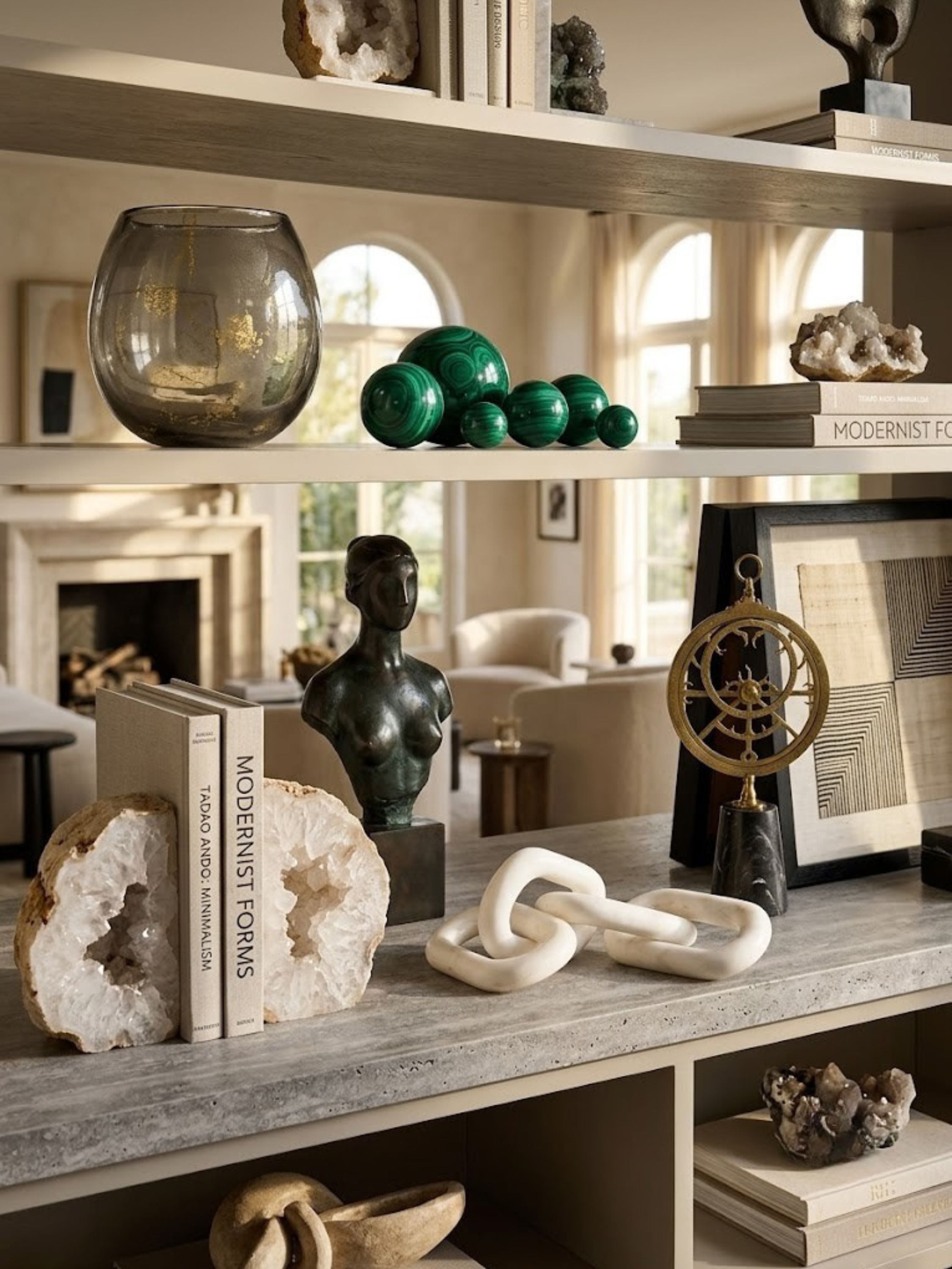 White marble chain-link sculpture displayed on a living room shelf among other objects.