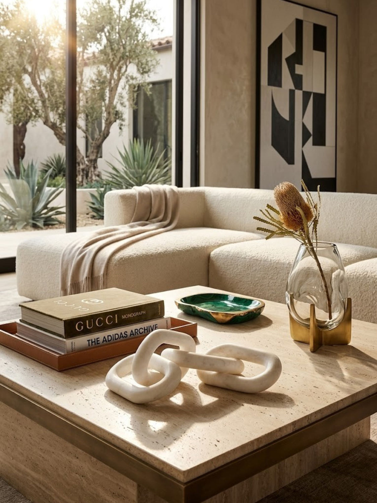 White marble chain-link sculpture styled on a living room coffee table.