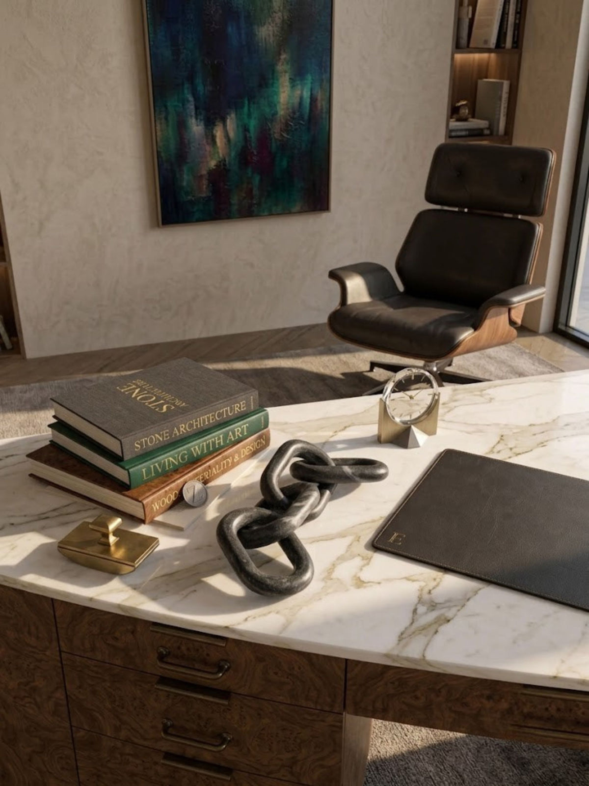 Black marble chain-link sculpture styled on a home office desk.