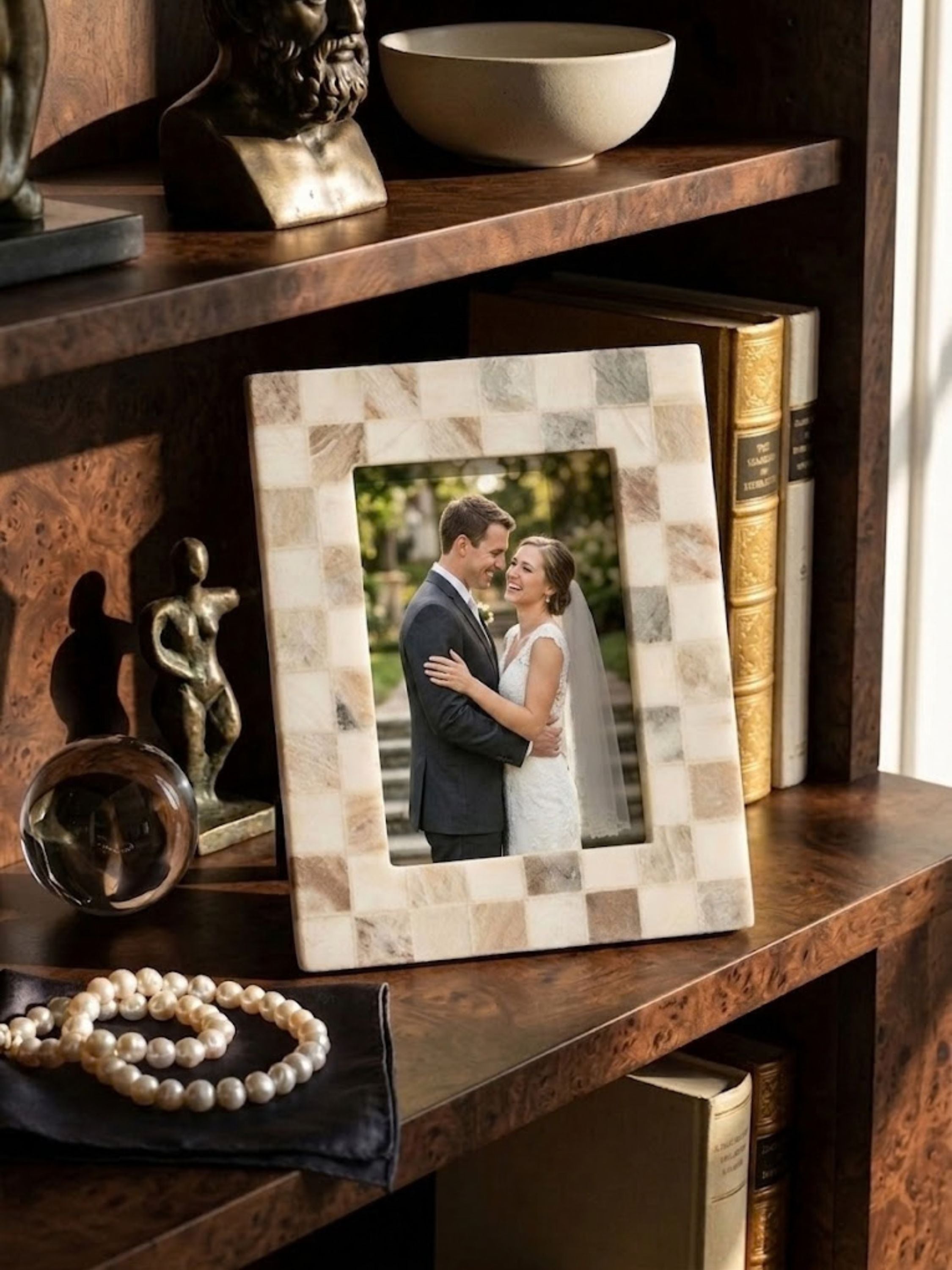 Austen brown onyx mosaic frame displayed within a bookshelf vignette, its warm hazel brown stone tiles among framed keepsakes.