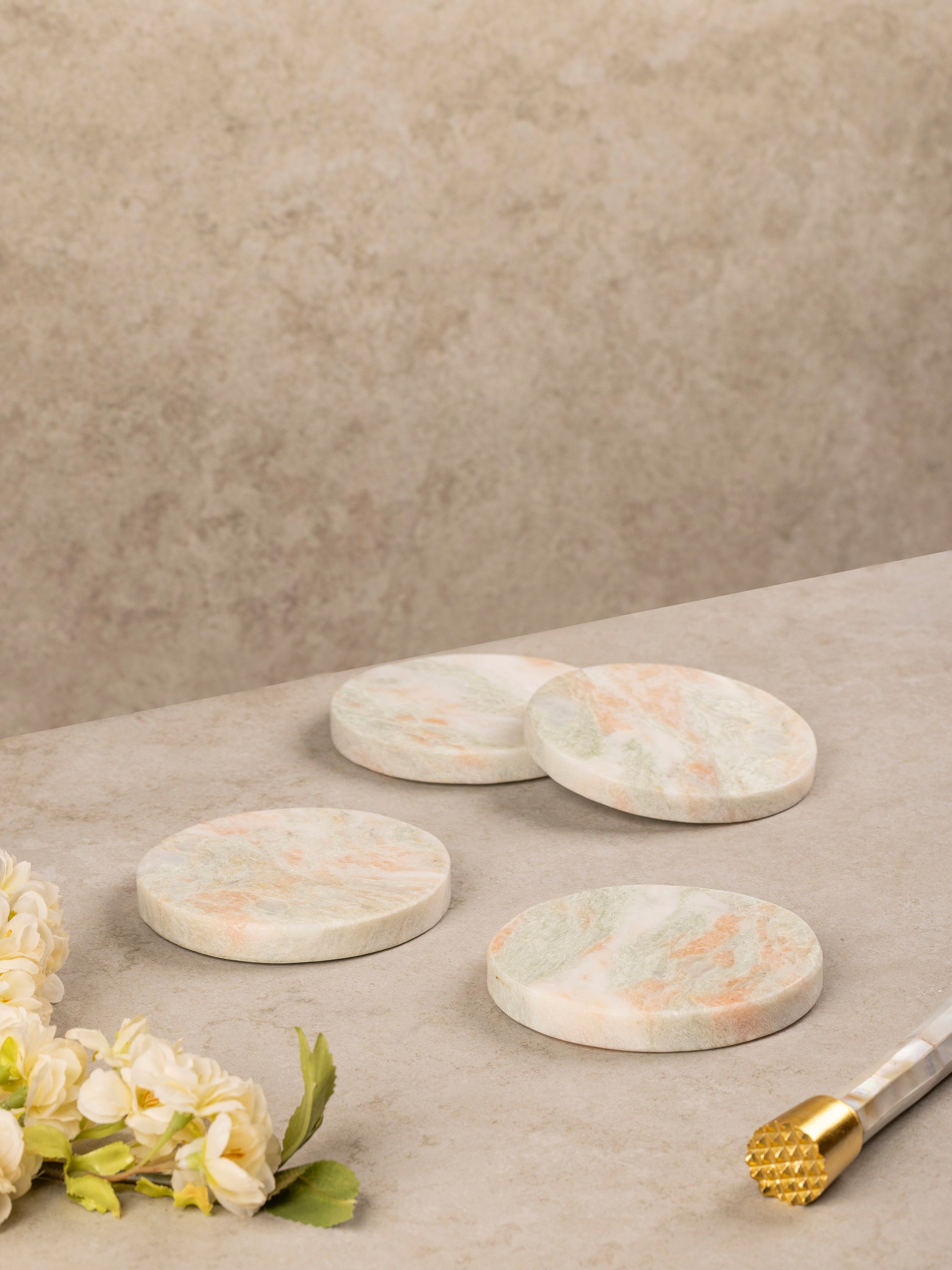 Moonlight onyx coasters stacked beside each other showing their round form, natural stone variation, and polished edges.