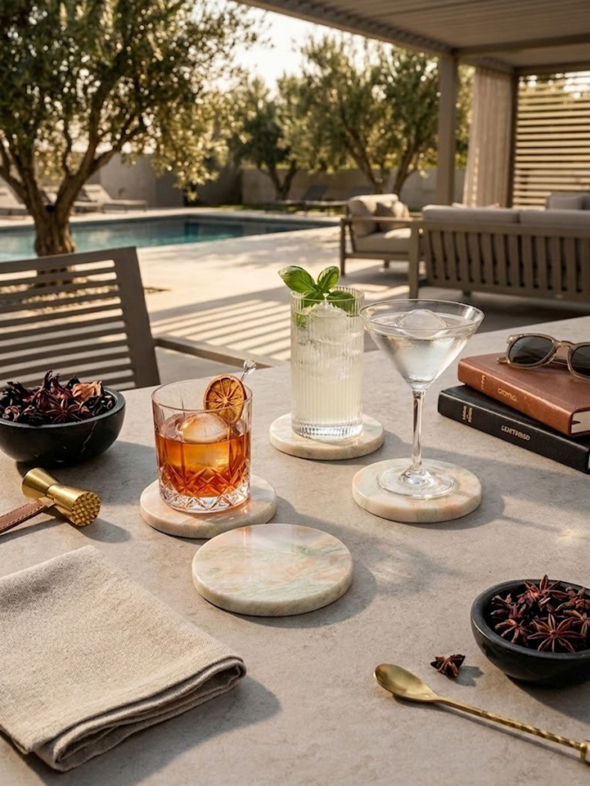 Onyx coaster set of four styled on an outdoor terrace table, sage-green veining across each piece.
