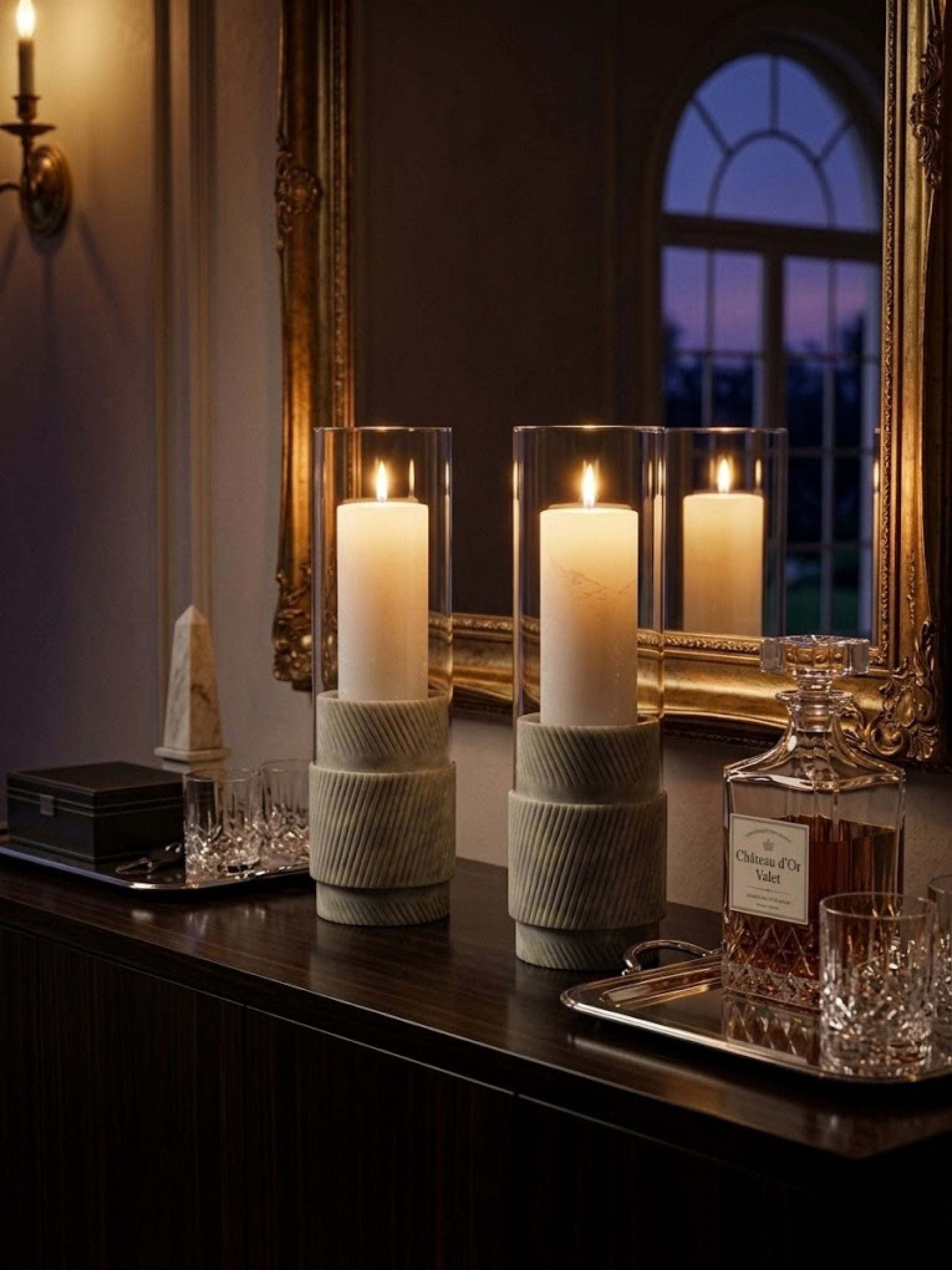 Estonia Green Onyx hurricane candle holders styled on a refined console table, showcasing fluted stone texture and warm candlelight for an elevated evening ambiance.