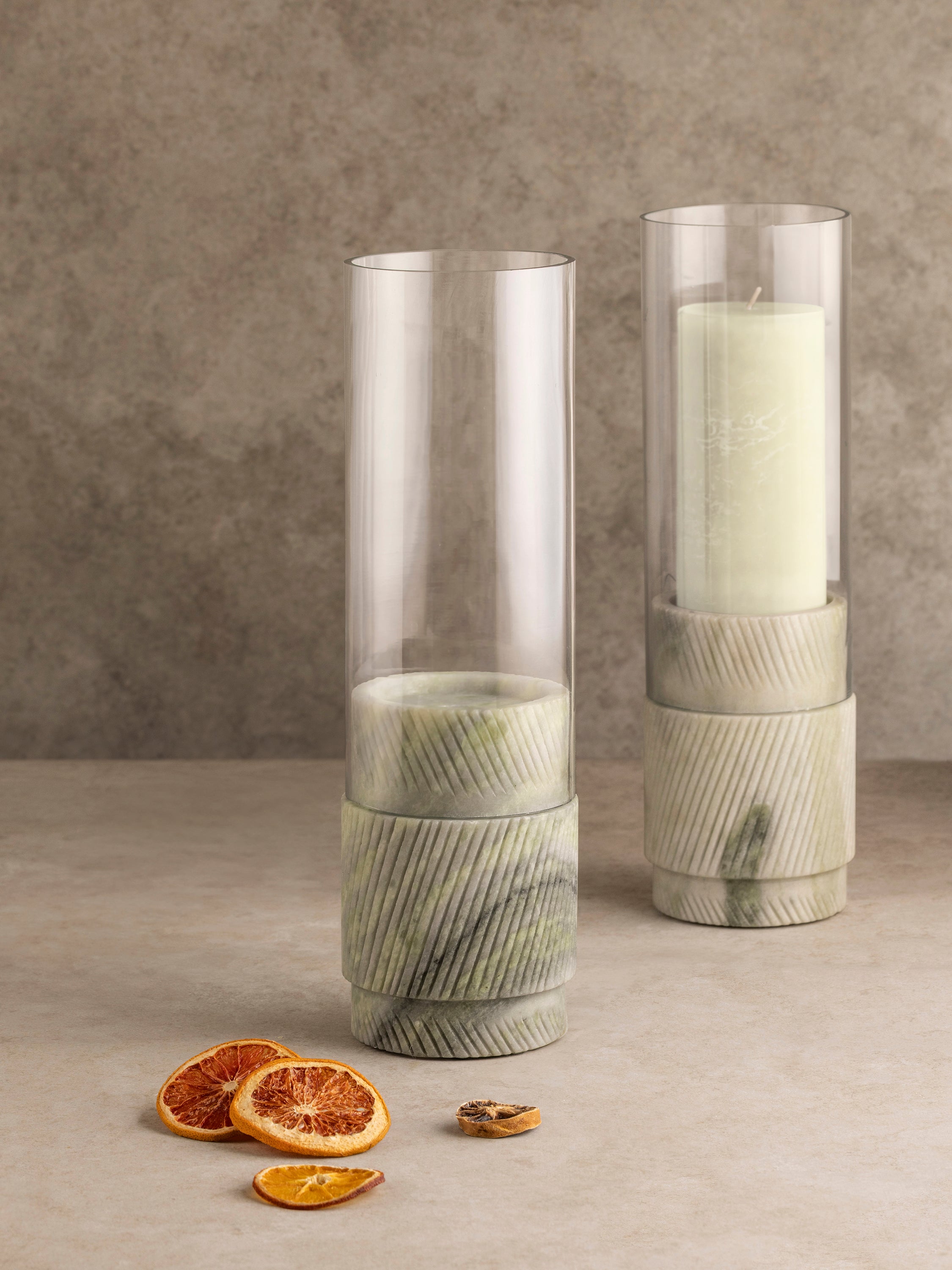 Estonia green onyx hurricane candle holder shown with glass cylinder in place, highlighting stone base carving and translucent mineral tones