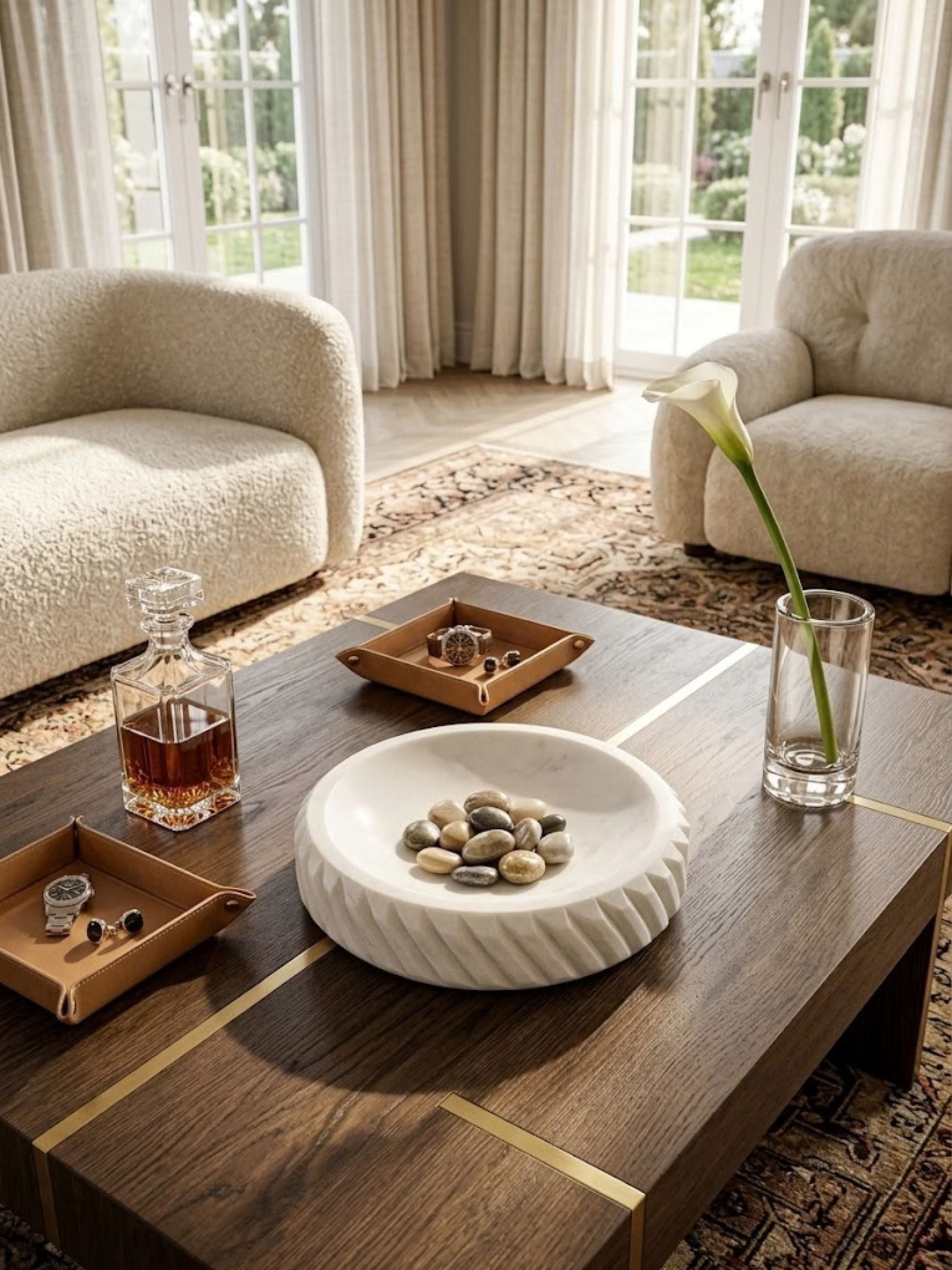 Charlotte marble bowl styled on an entryway console among jewelry trays and crystal accents, its carved form on display.