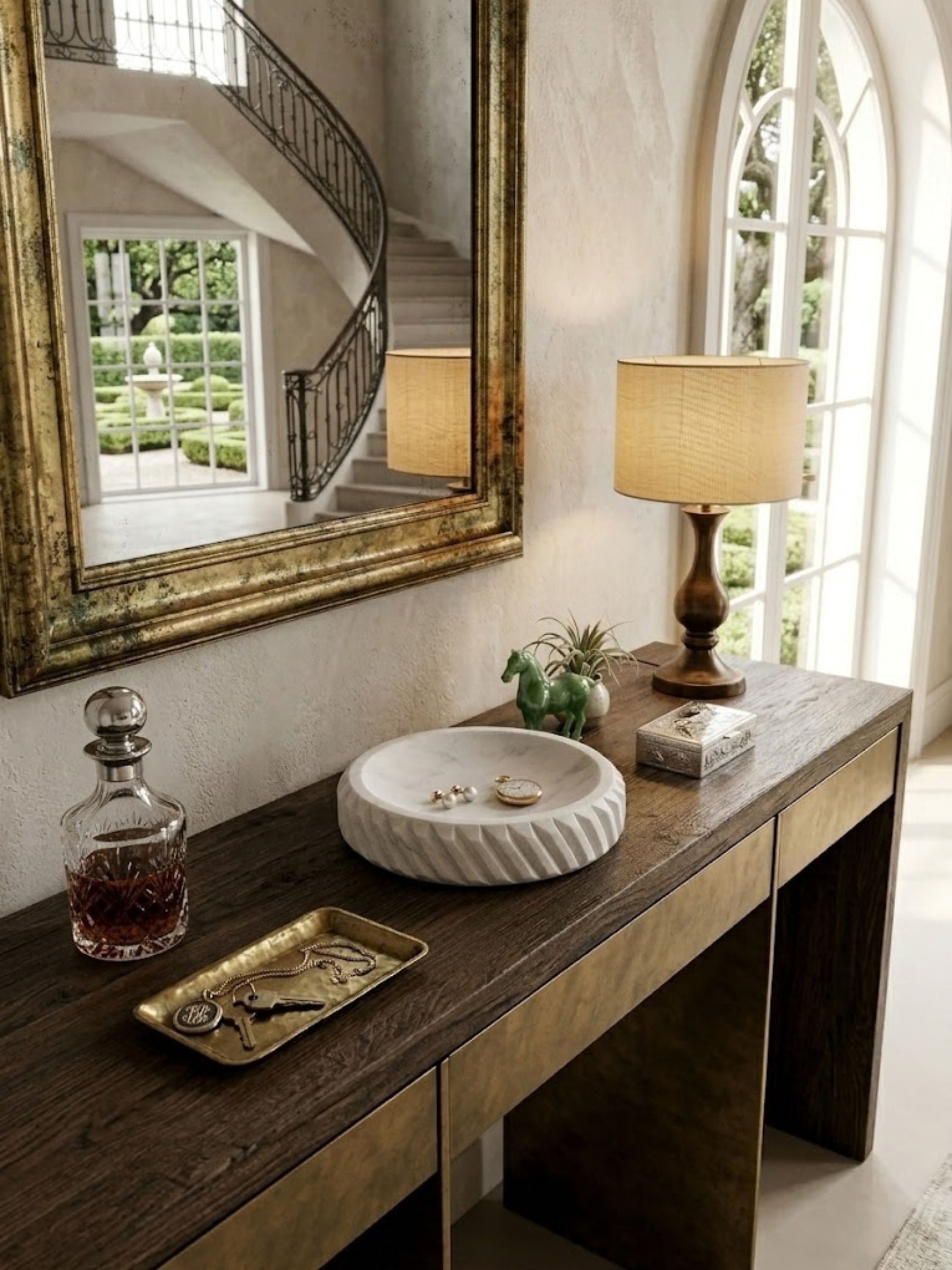 Charlotte marble bowl styled in a dressing room holding jewelry and watches, highlighting its sculptural ribbed form.