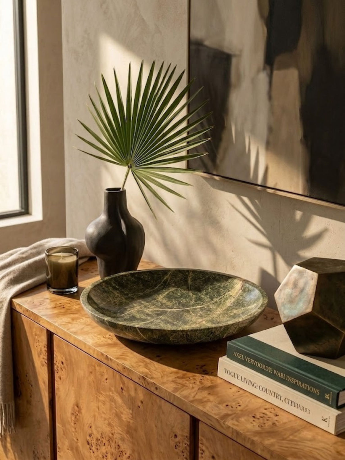Green marble bowl with a tapered rim, styled on a console.