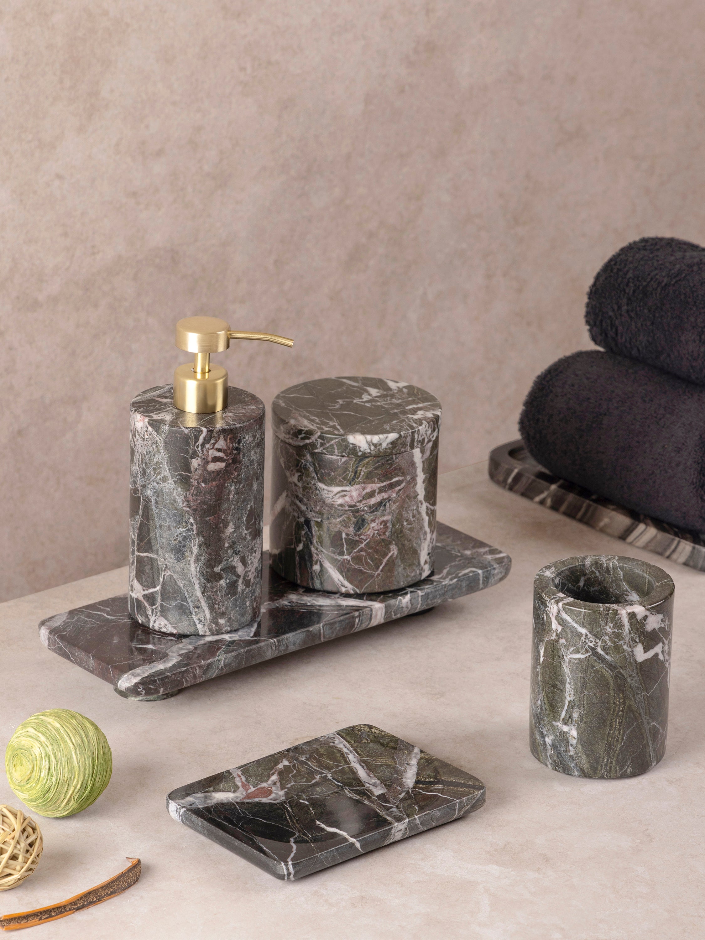Green marble bath accessories set with soap dispenser, canister, and soap dish with brass pump, shown in a clean front-facing composition