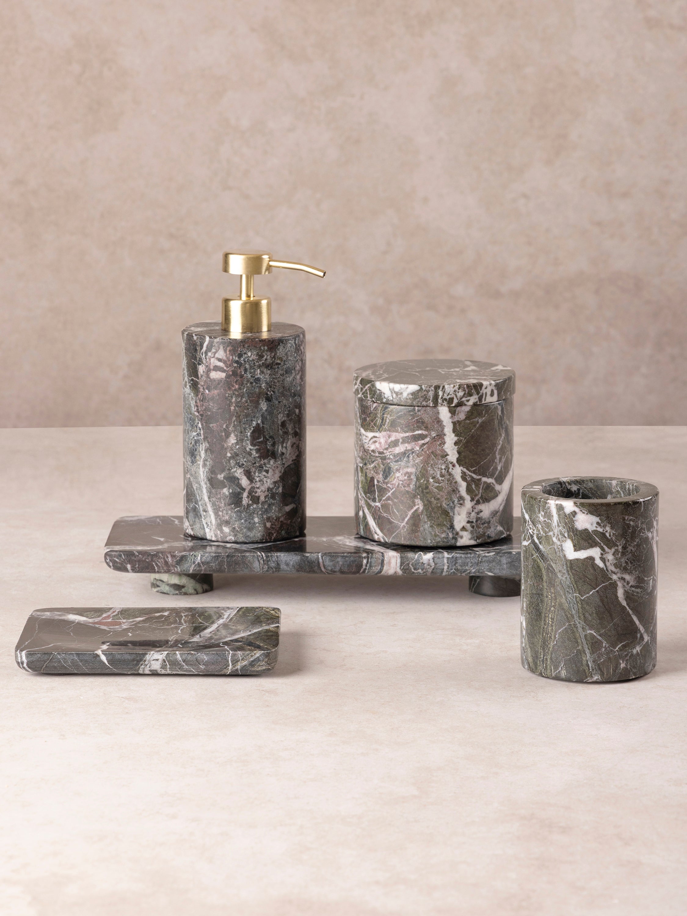 Jardin Verde Levanto bath set components shown together highlighting cylindrical stone forms and brass pump detailing