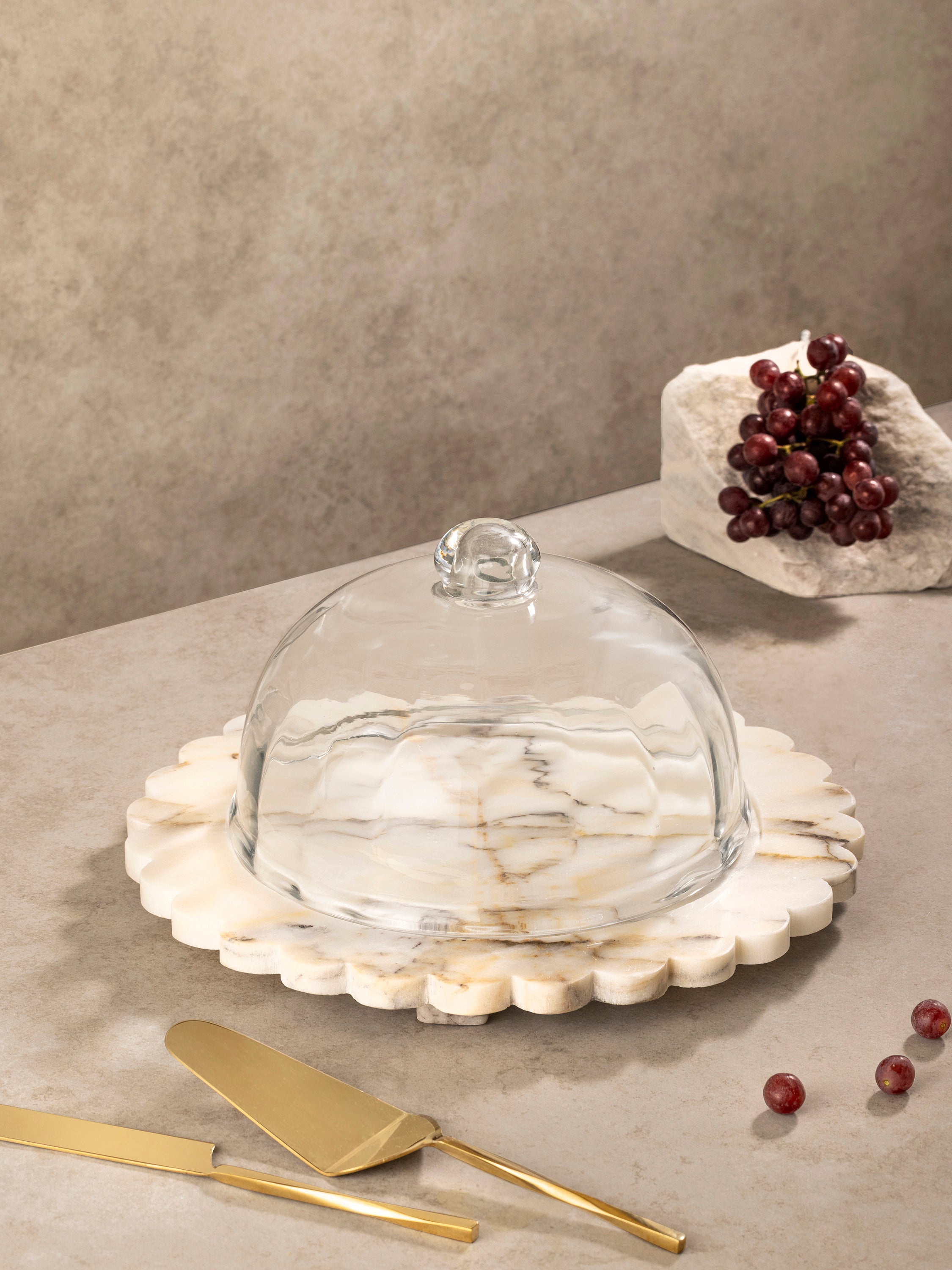 Scalloped onyx cheese board with organic edge and glass cloche cover, shown in a clean front-facing composition