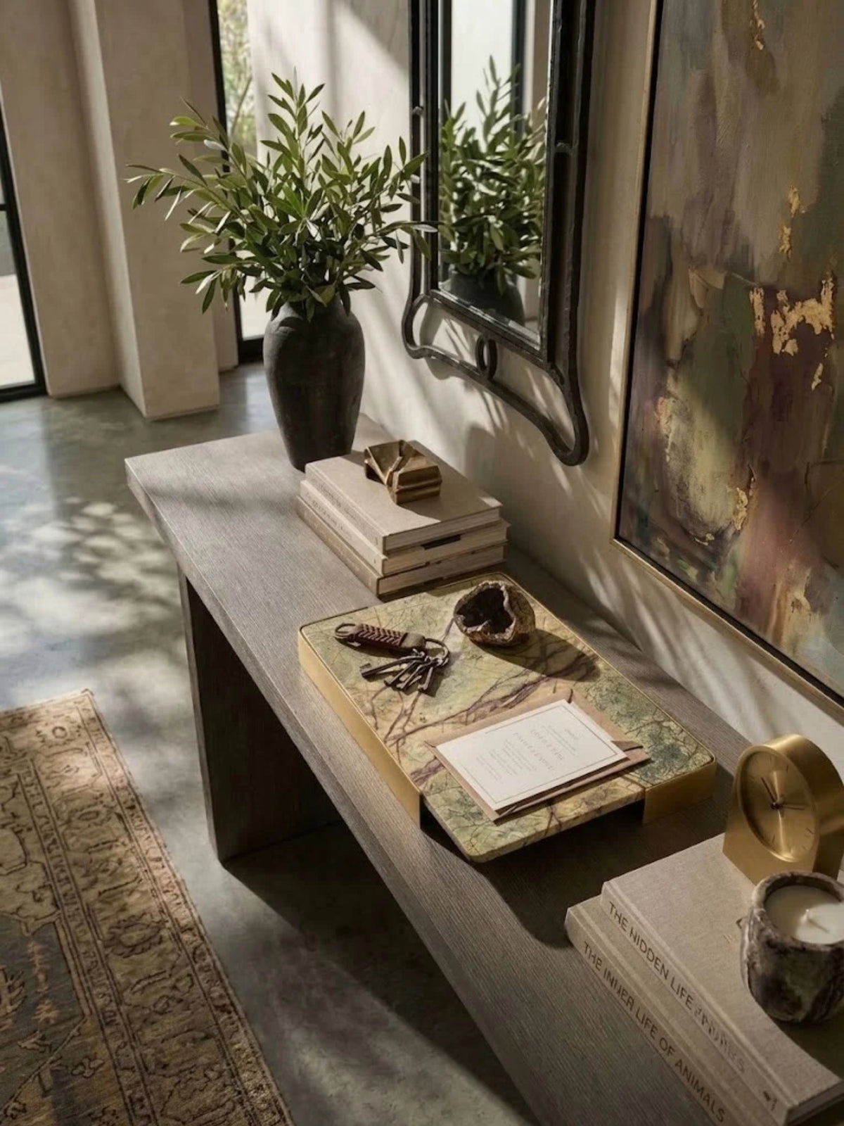 Normandy onyx marble tray with russet veining, holding a notebook and glasses on an entryway console.