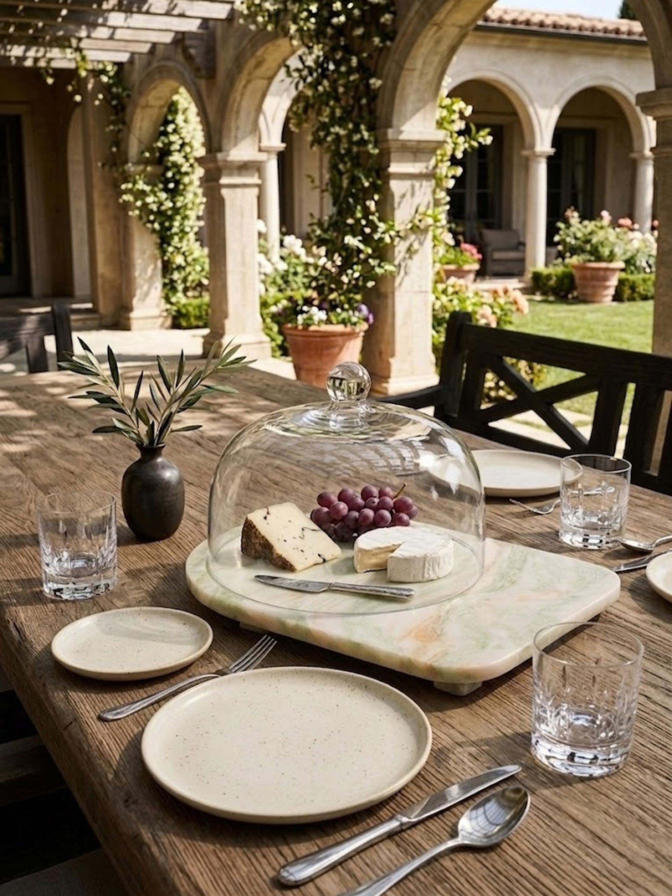 Moonlight onyx cloche board displayed for outdoor entertaining, pairing luminous onyx tones with a glass cloche for relaxed gathering moments.