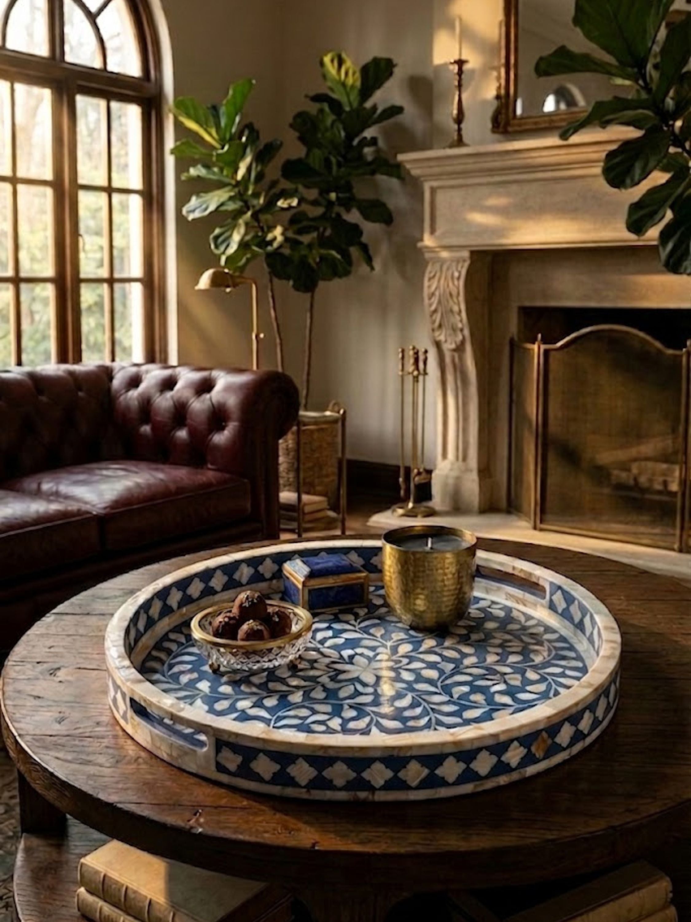 Round mother of pearl inlay decorative tray in blue and ivory geometric pattern, styled on a wooden coffee table in a warm living room setting