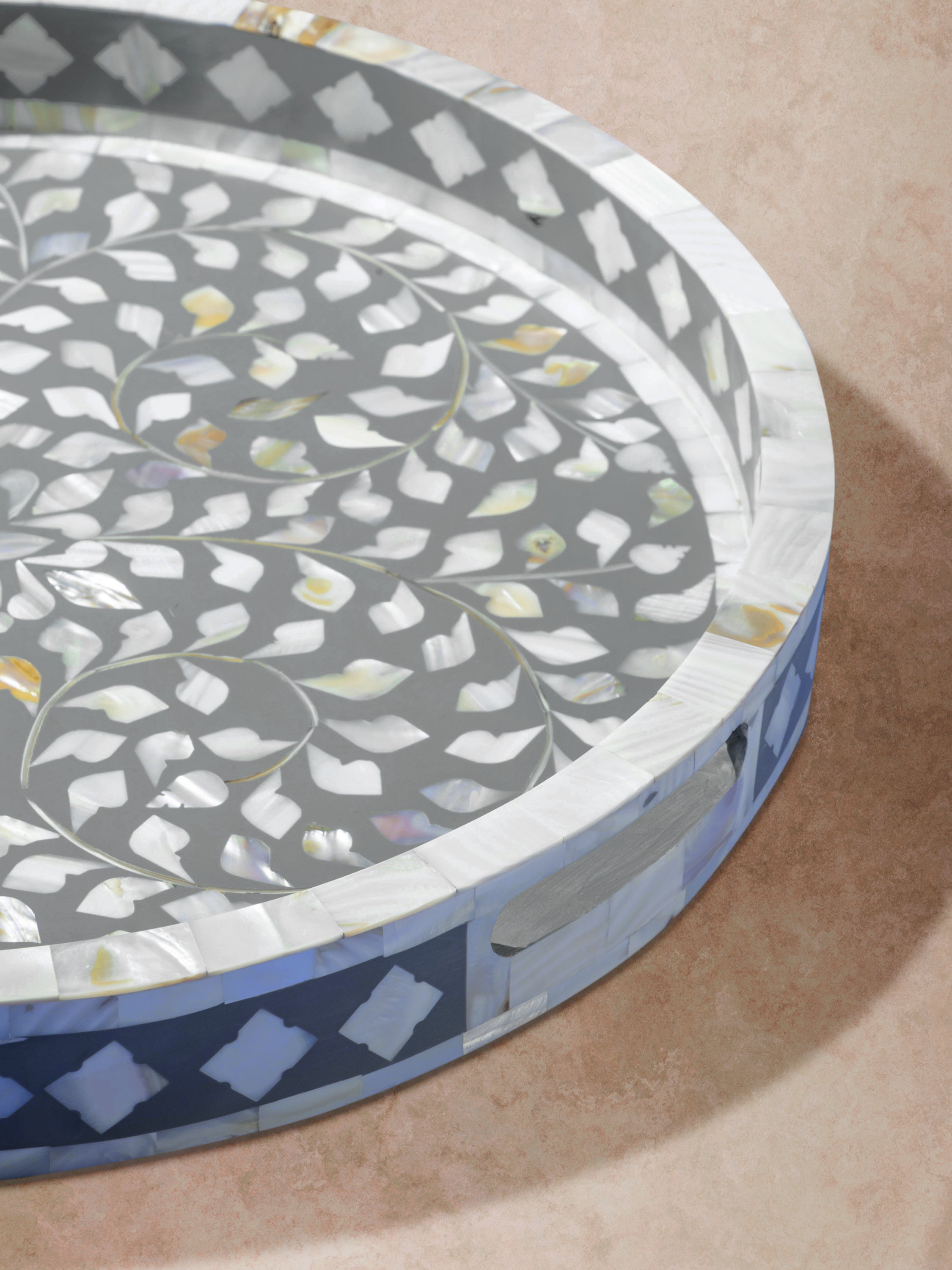 Close-up of grey inlay tray highlighting raised edge, integrated handles, and fine craftsmanship of inlaid pattern