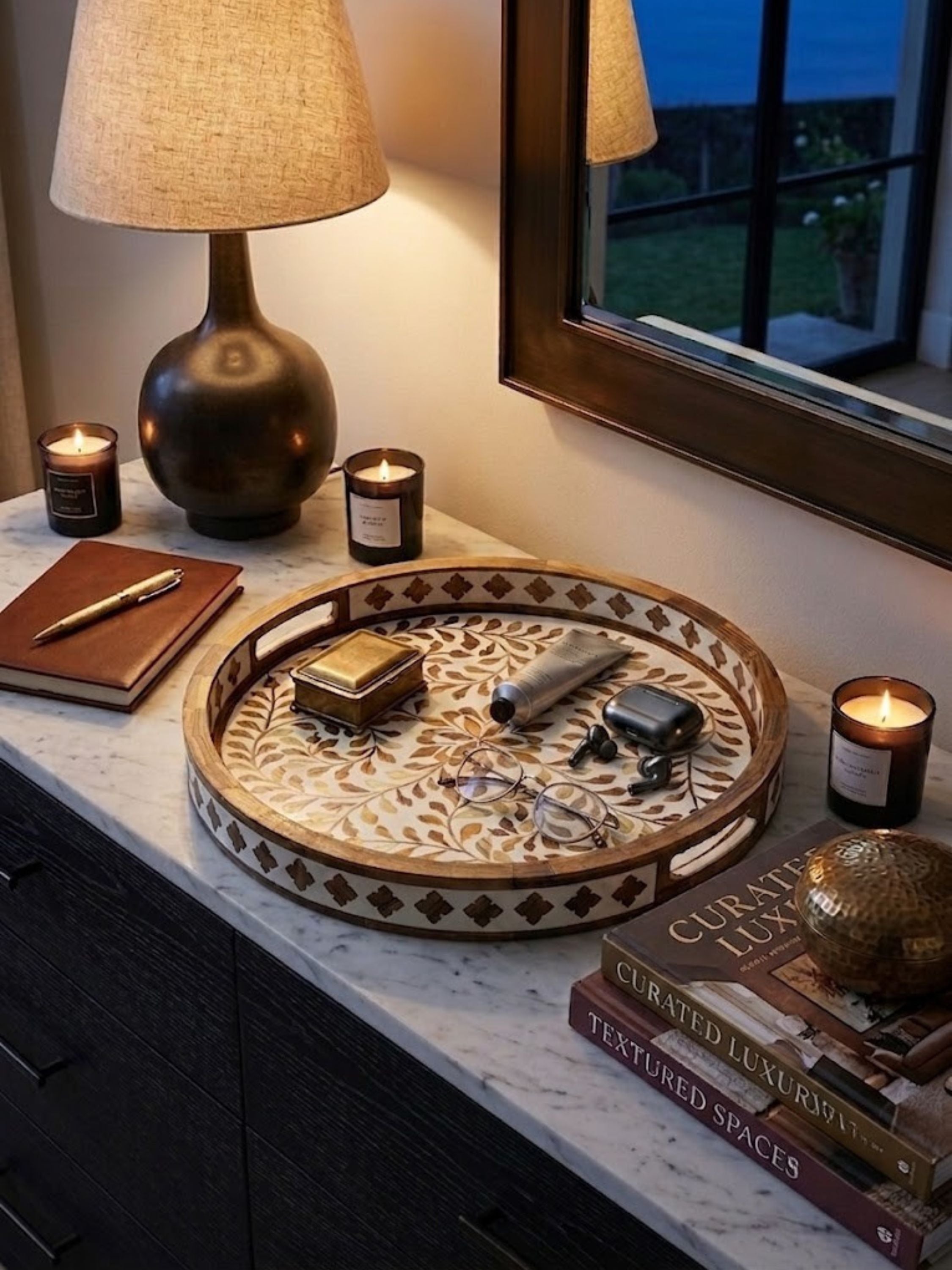 Mother of pearl inlay round tray with a warm wood-toned ground, styled on a bedroom dresser.