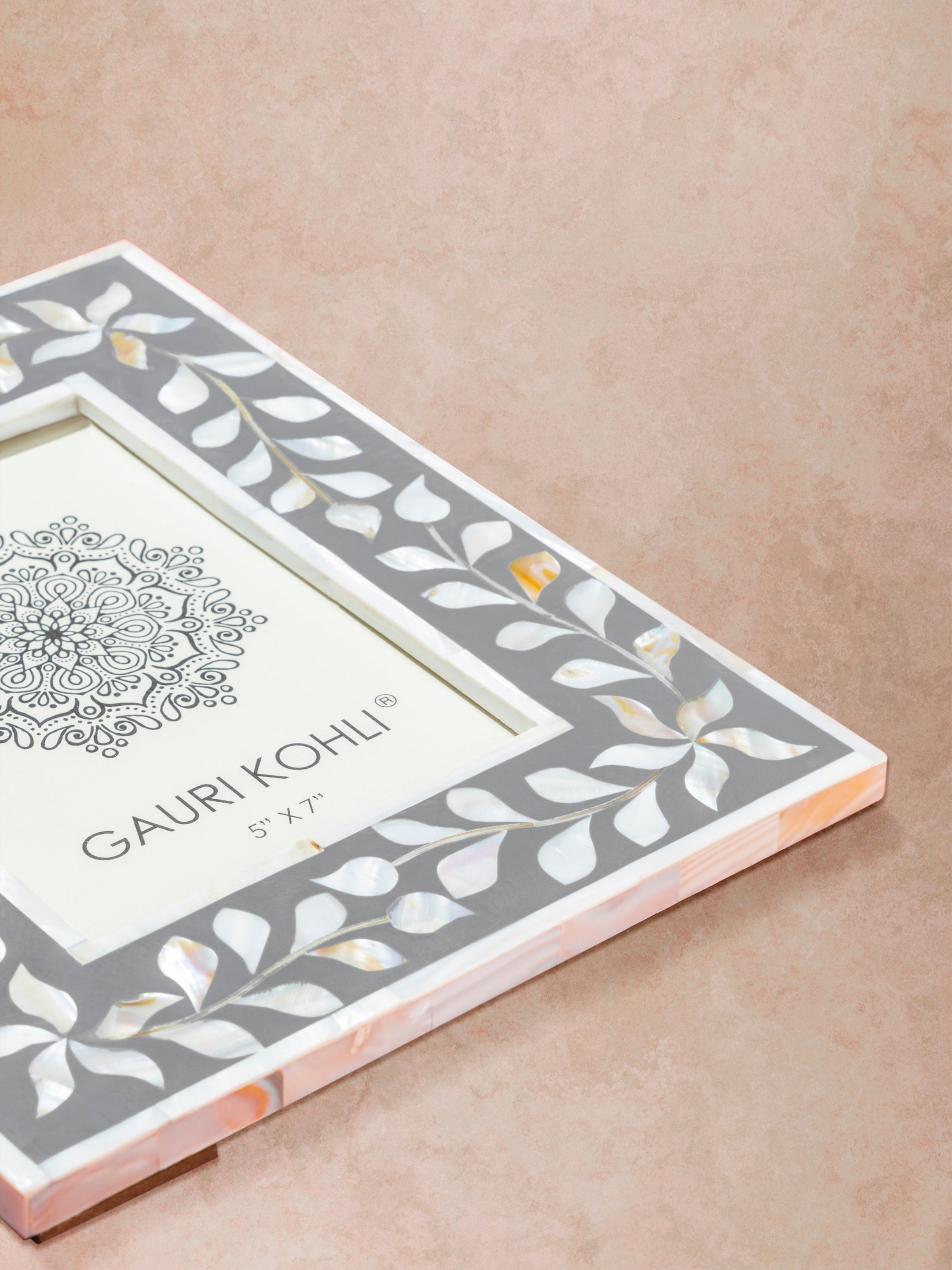 Close-up of grey inlay frame showing fine bone inlay craftsmanship, smooth finish, and layered edge construction