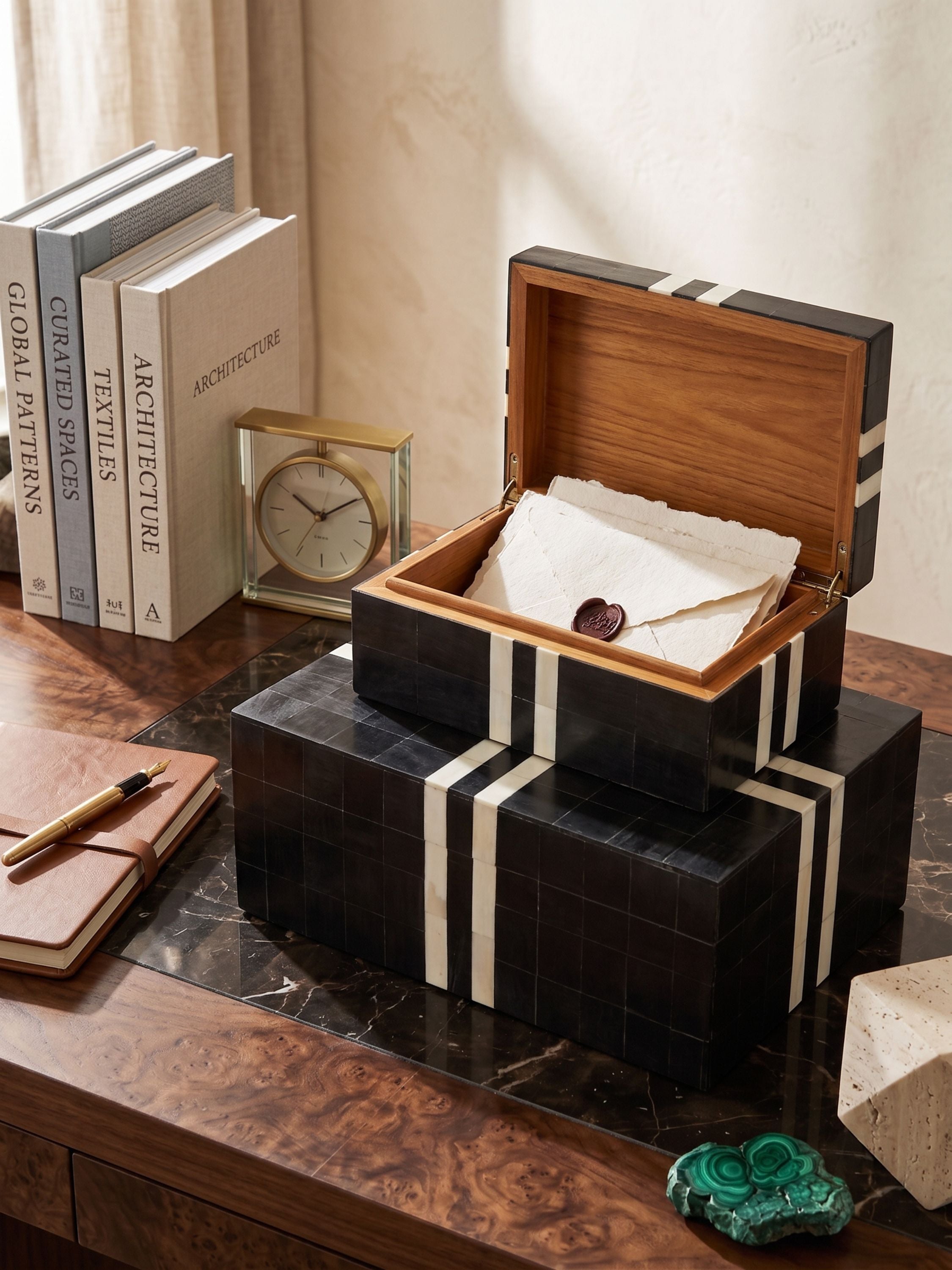 Bone and horn inlay striped keepsake boxes set of two styled open and closed on a wooden desk with books, clock, and writing accessories